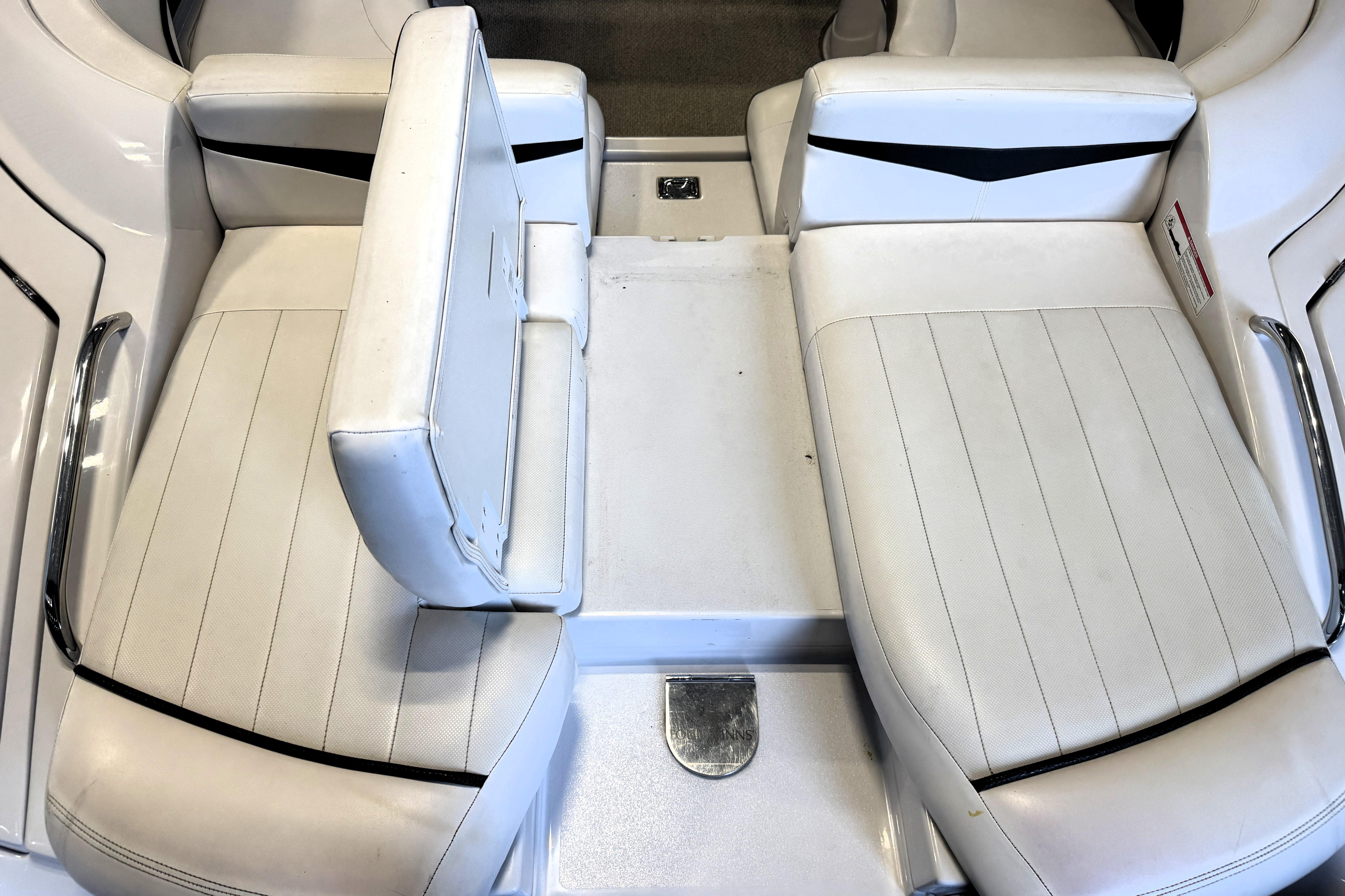 2008 Four Winns H240 boat interior with white seating and chrome accents.