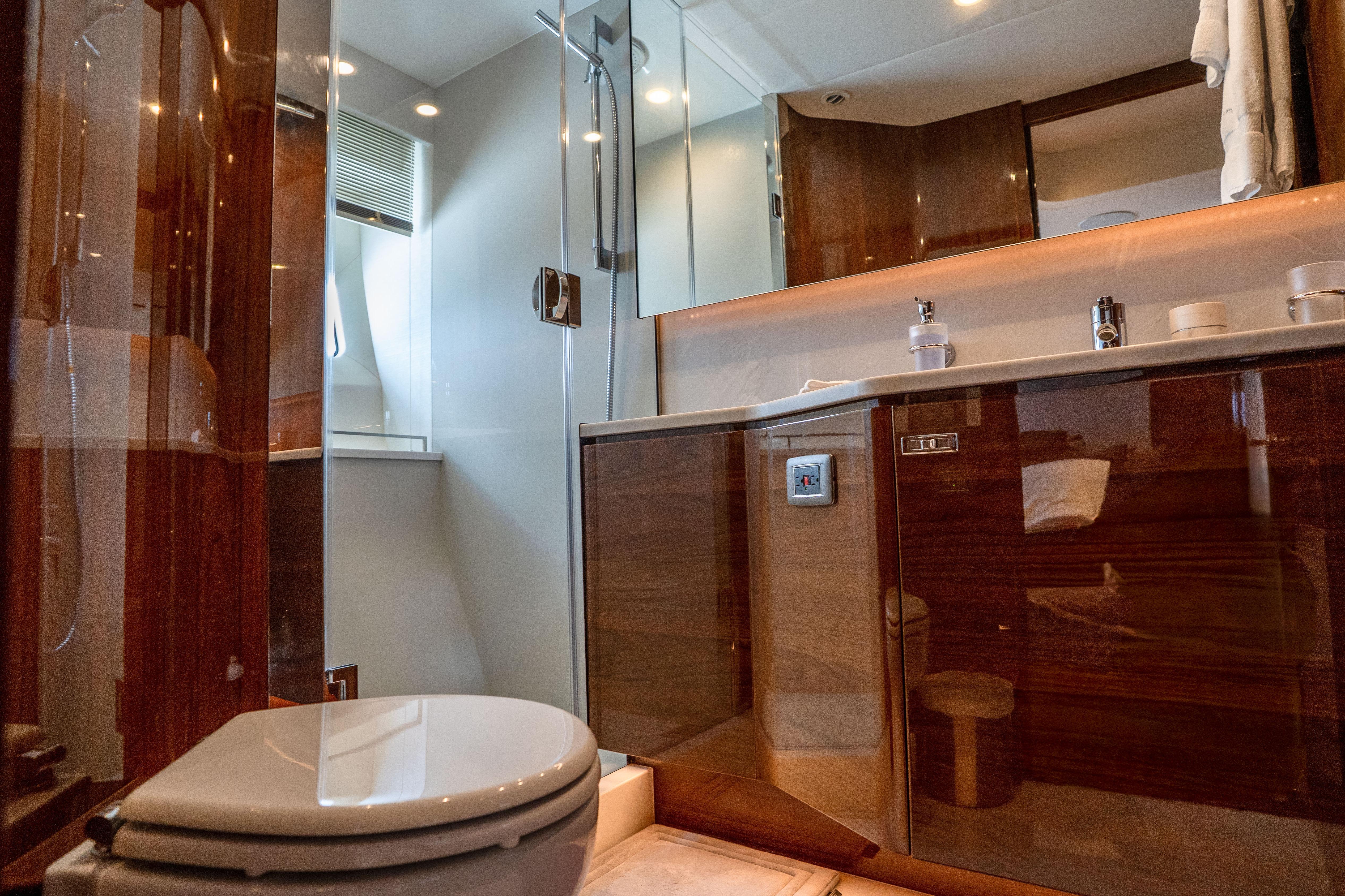 Luxurious bathroom in 2020 Princess Y85 yacht with modern fixtures and elegant wood finishes.