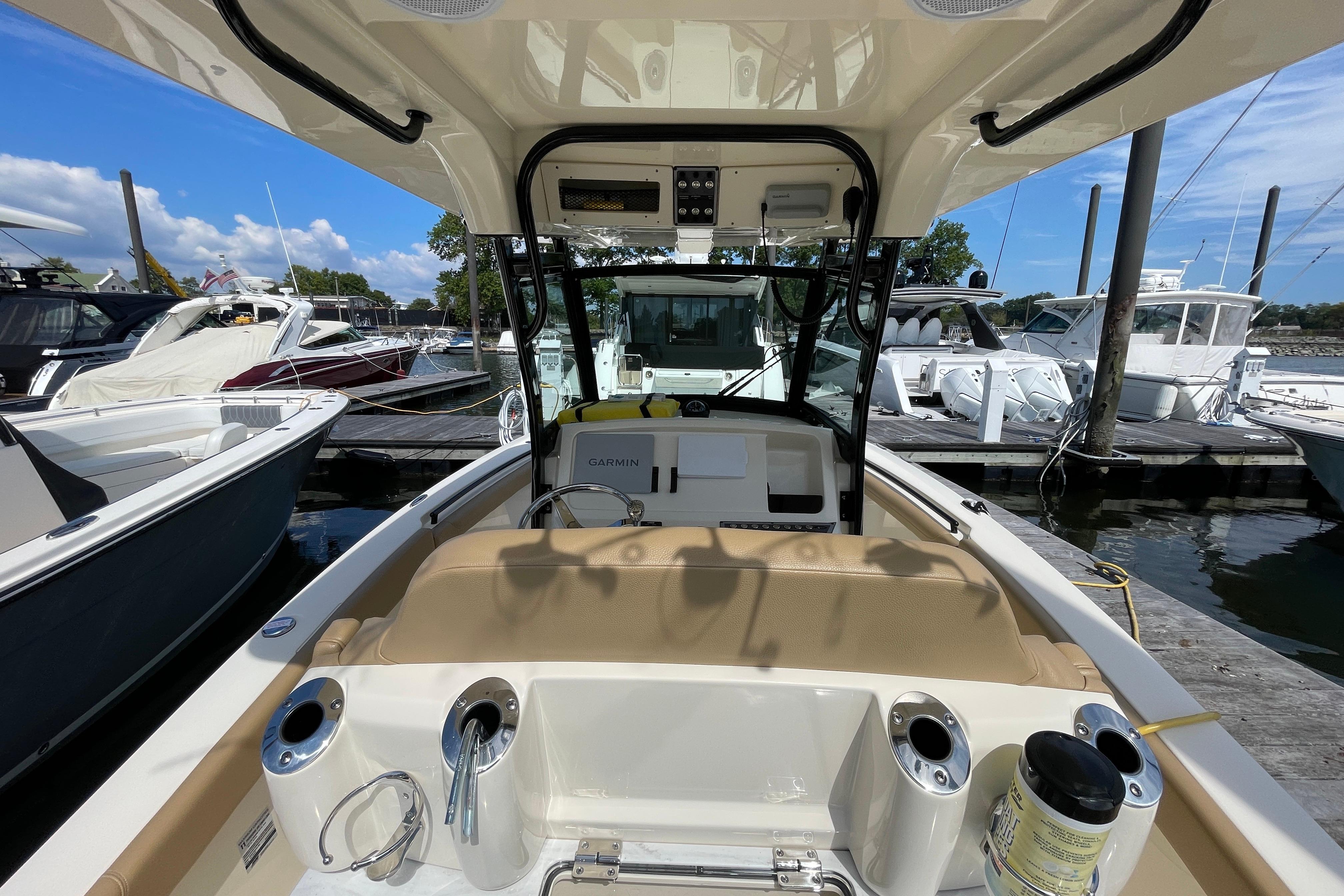 2020 Scout 255 LXF boat interior at marina, featuring helm and seating area.