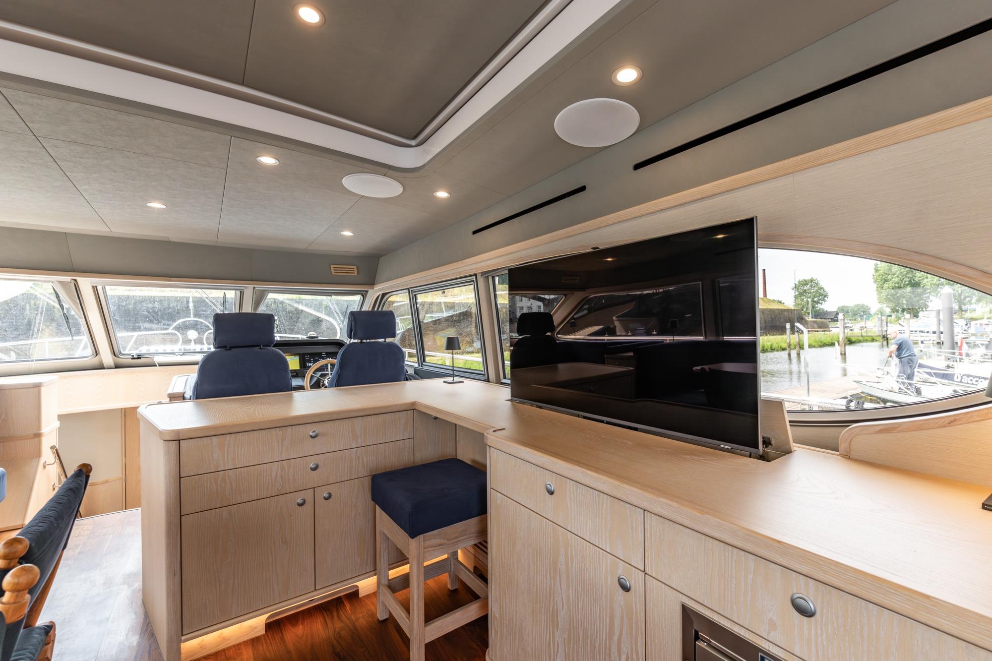 Luxurious interior of 2025 Elling E6 yacht with modern furnishings and large windows.