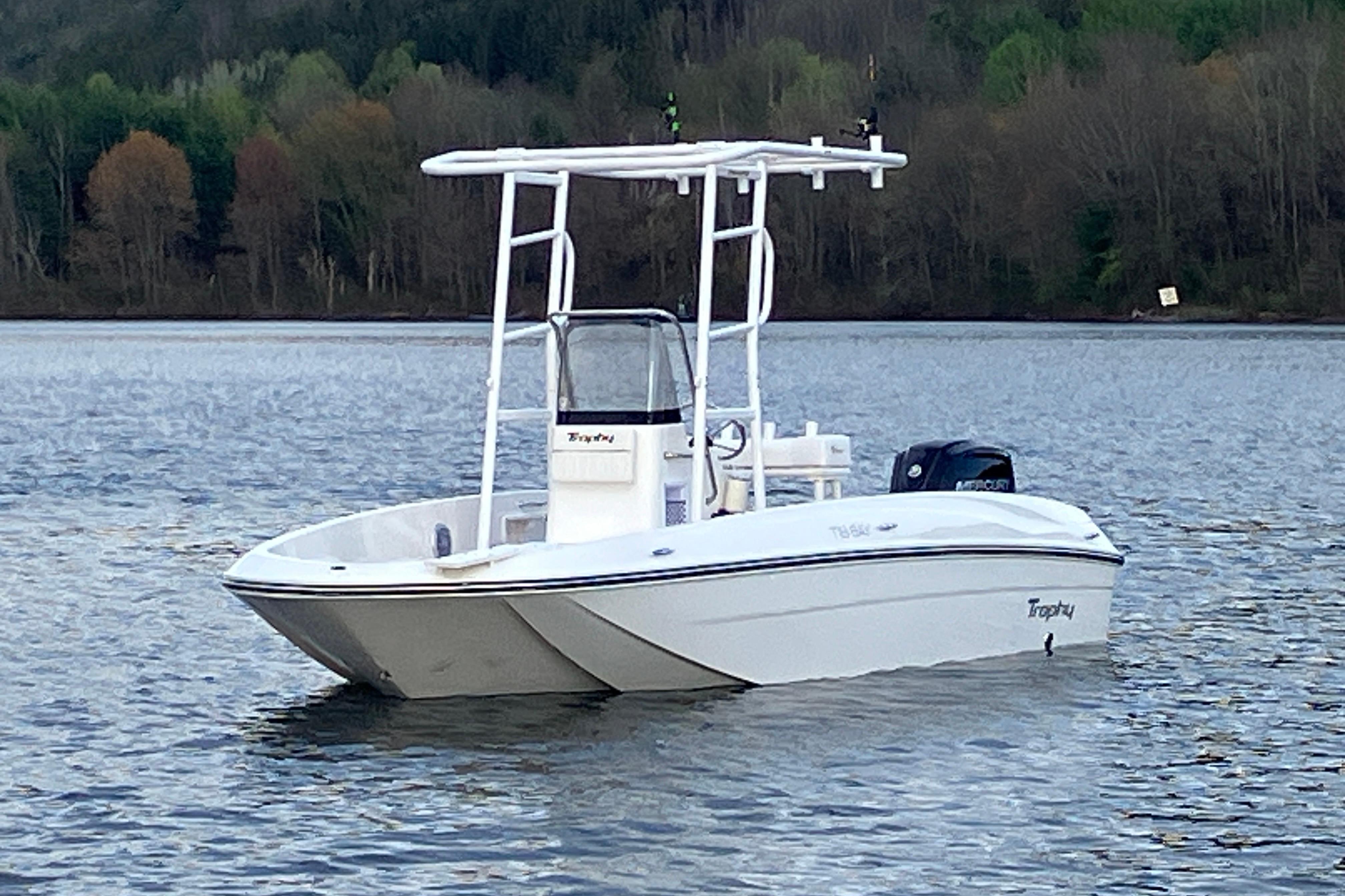 2026 Bayliner Trophy T18 boat on a calm lake with forested background.