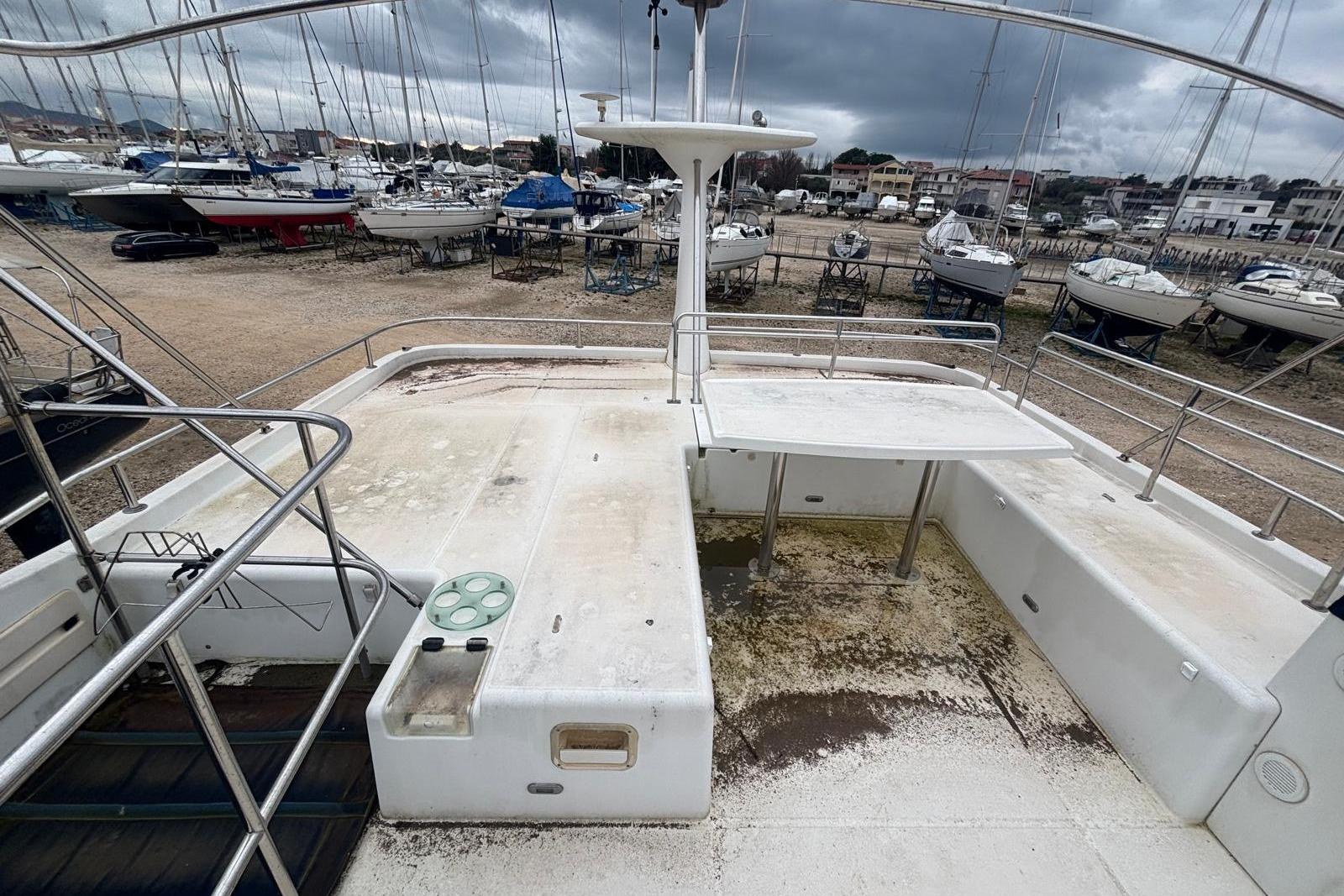2007 Lagoon Power 44 yacht deck, showing spacious layout and railing, in a boatyard setting.
