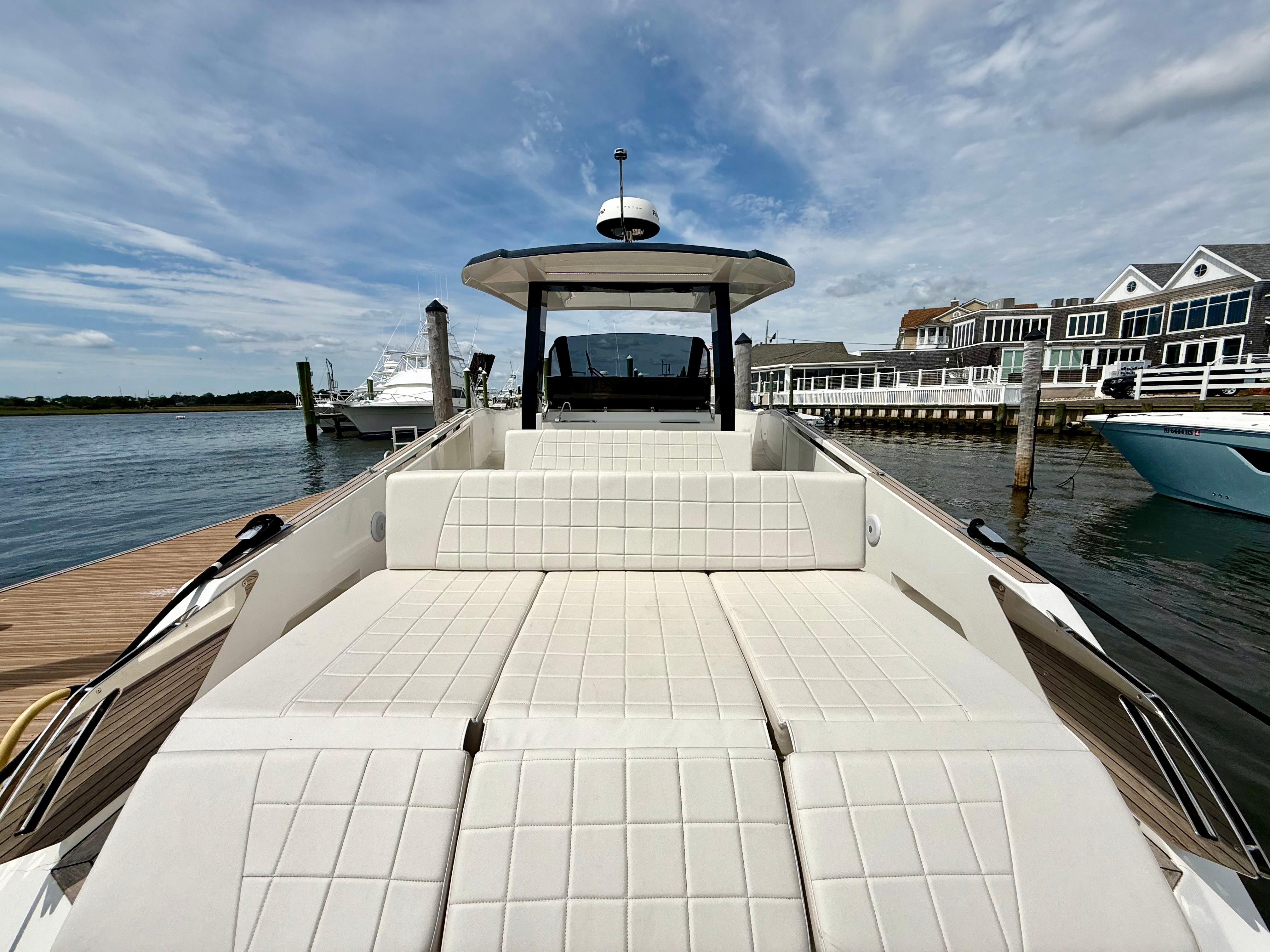 2023 Astondoa 377 Coupe Outboard yacht docked, featuring spacious sunbathing area and modern design.