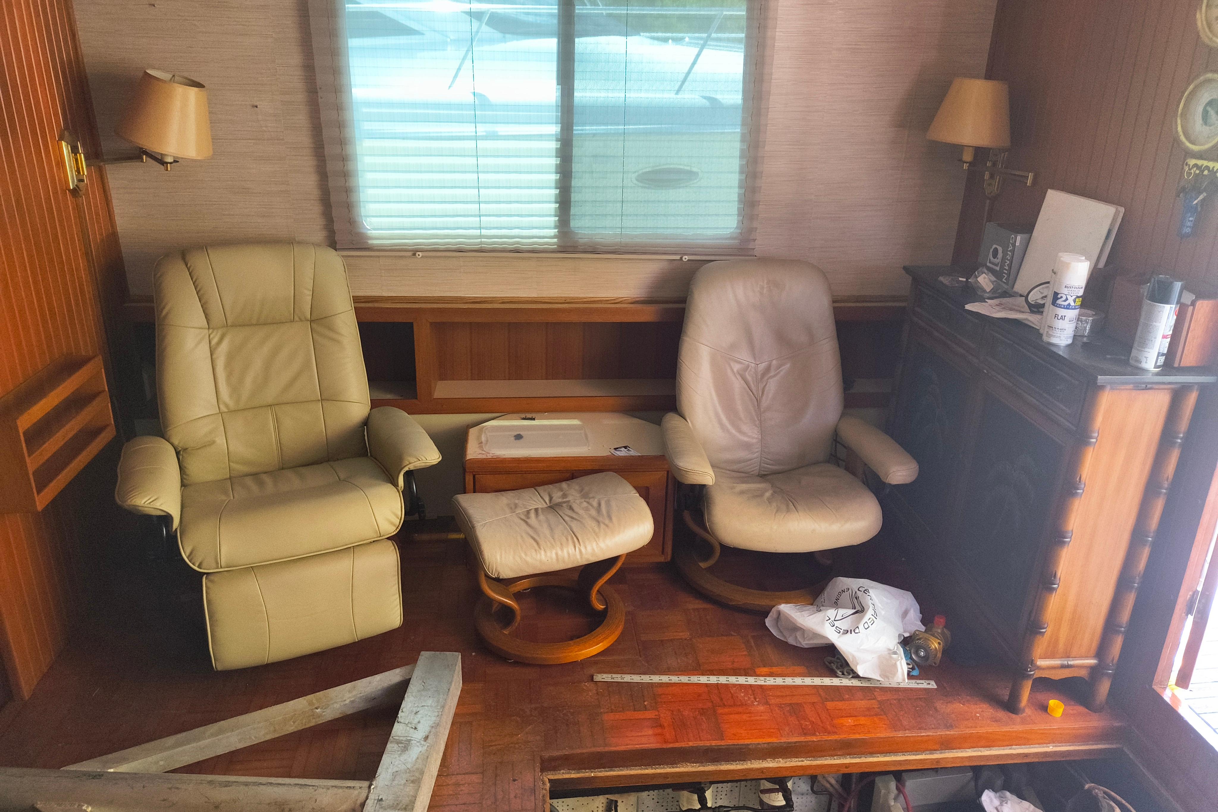 Interior of a 1984 Kadey-Krogen Manatee with beige recliners and wooden furniture.