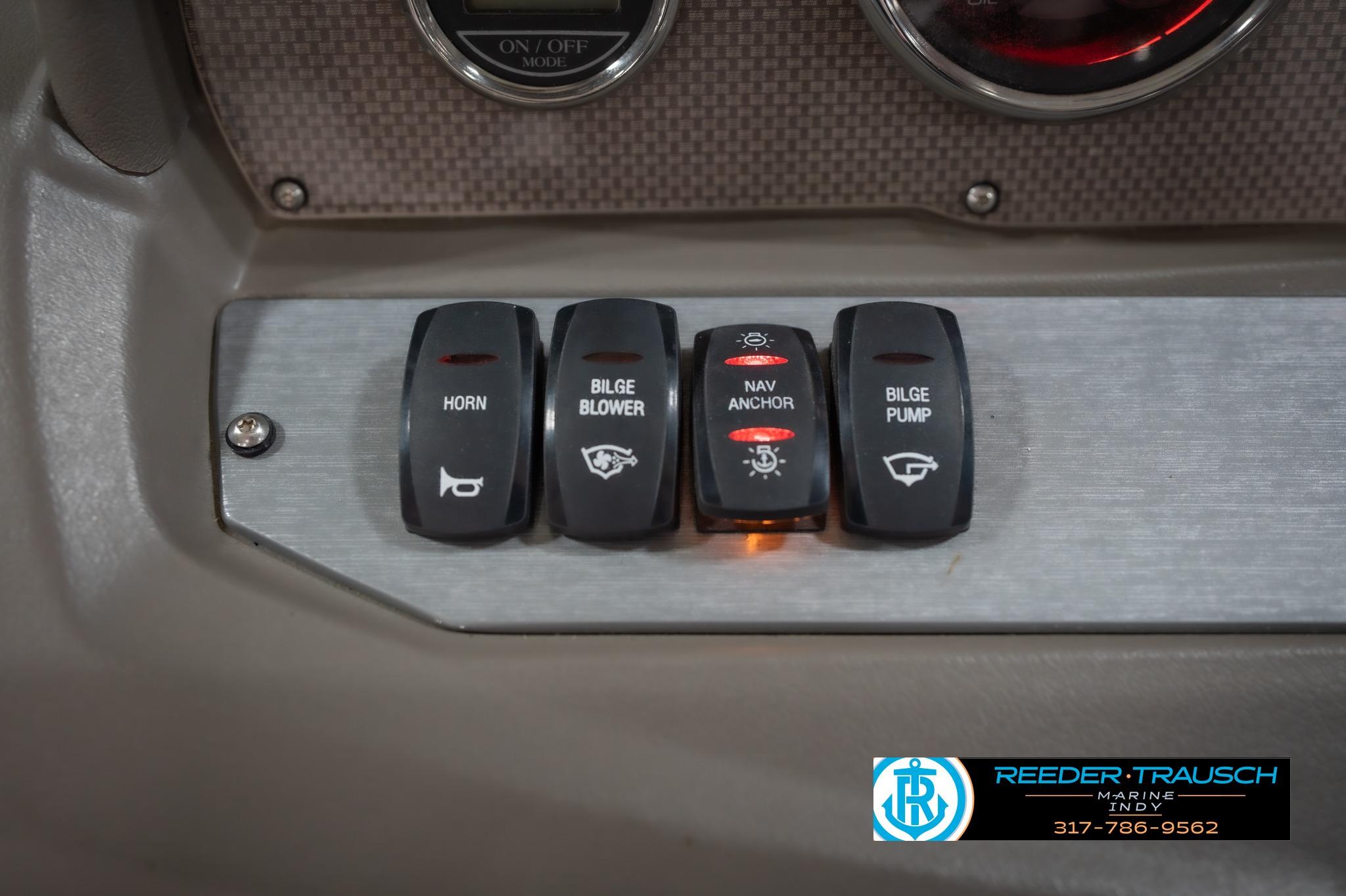Control panel of a 2015 Regal 2000 ESX Bowrider with labeled switches.