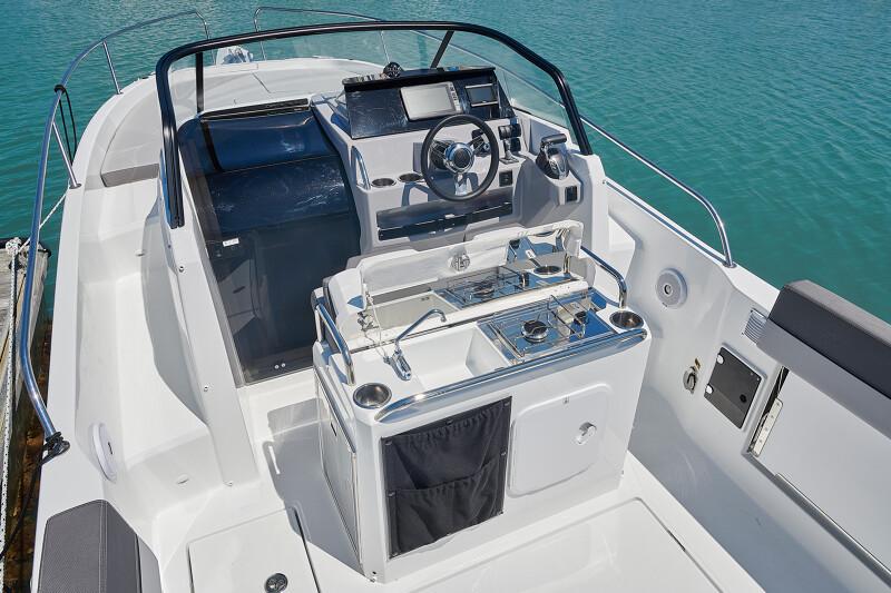 2024 Jeanneau Leader 7.5 boat cockpit with steering wheel and control panel.