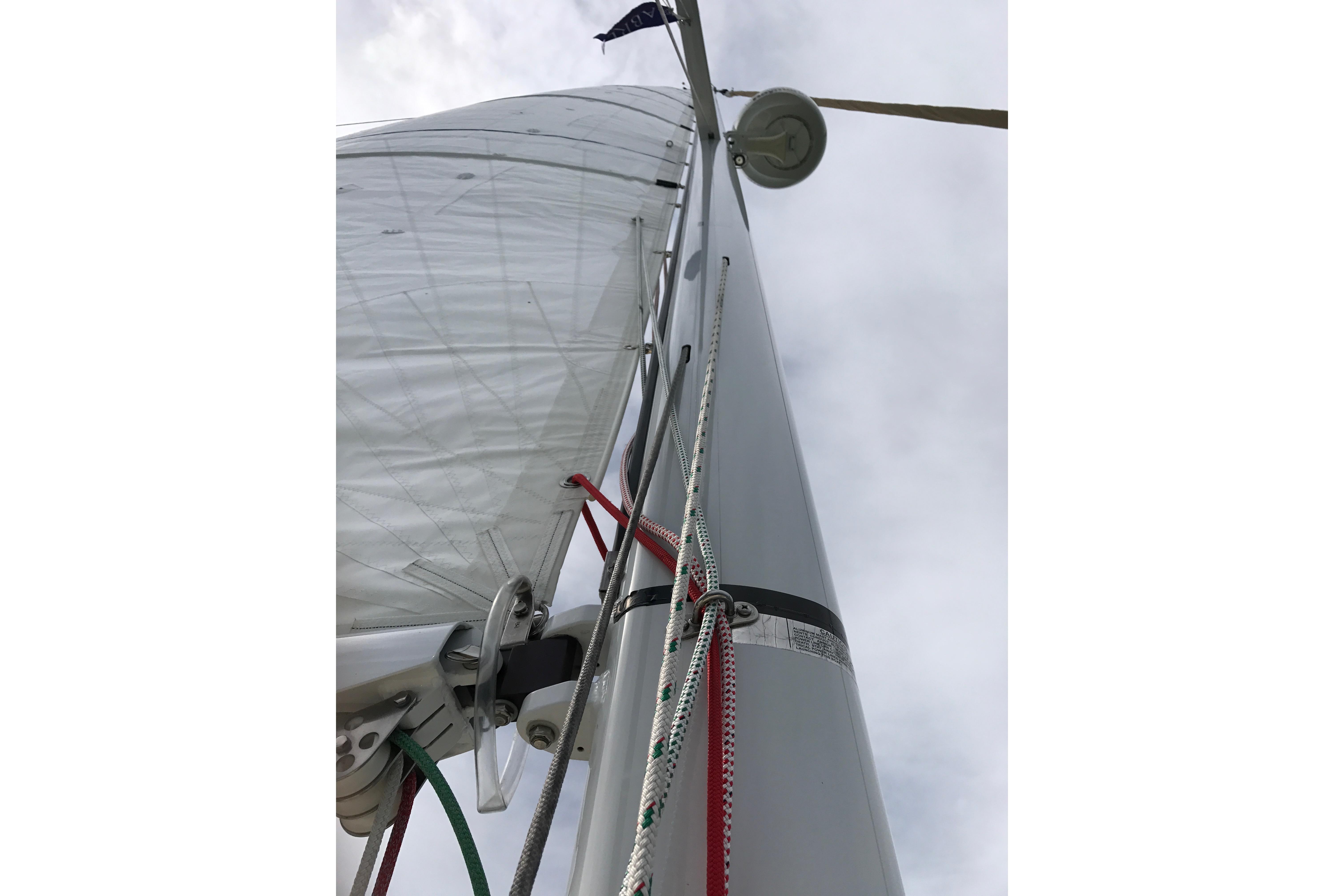 Close-up of a 2007 Sabre 386 sailboat mast and rigging against a cloudy sky.