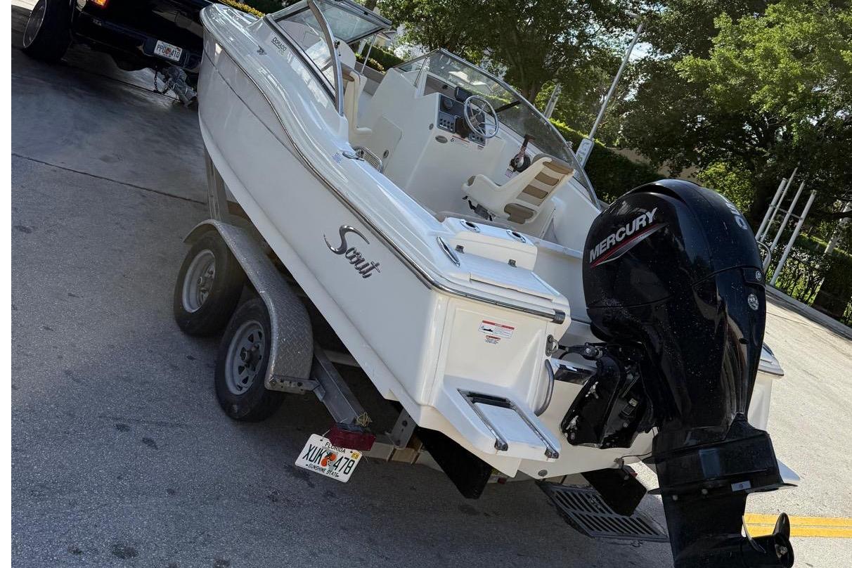 2023 Scout 210 Dorado boat on trailer with Mercury outboard engine.