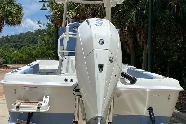 2025 Ranger 2360 Bay boat with powerful outboard motor, set against a lush, tropical backdrop.
