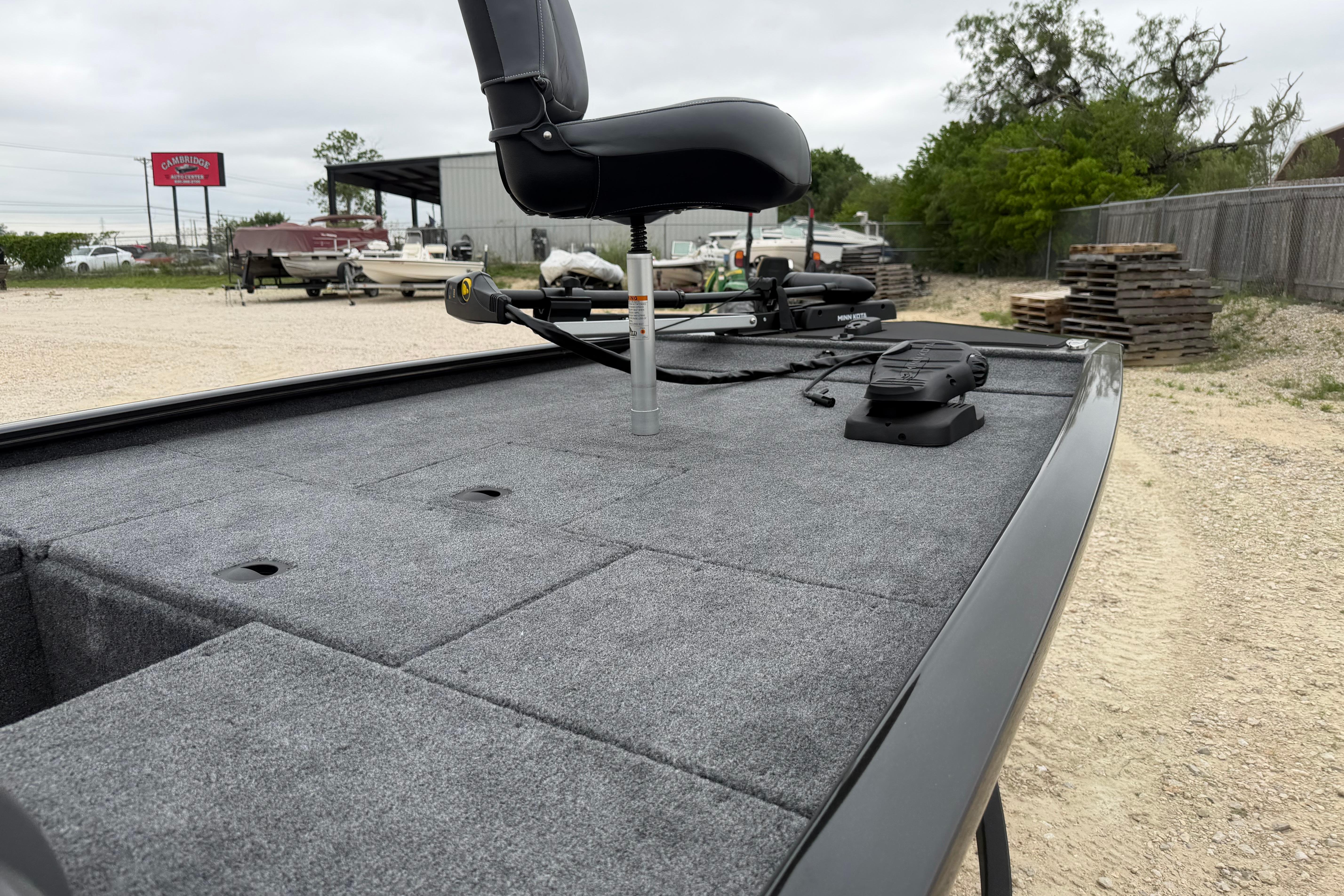 2026 Tracker Pro 170 boat deck with seating and equipment, parked outdoors.