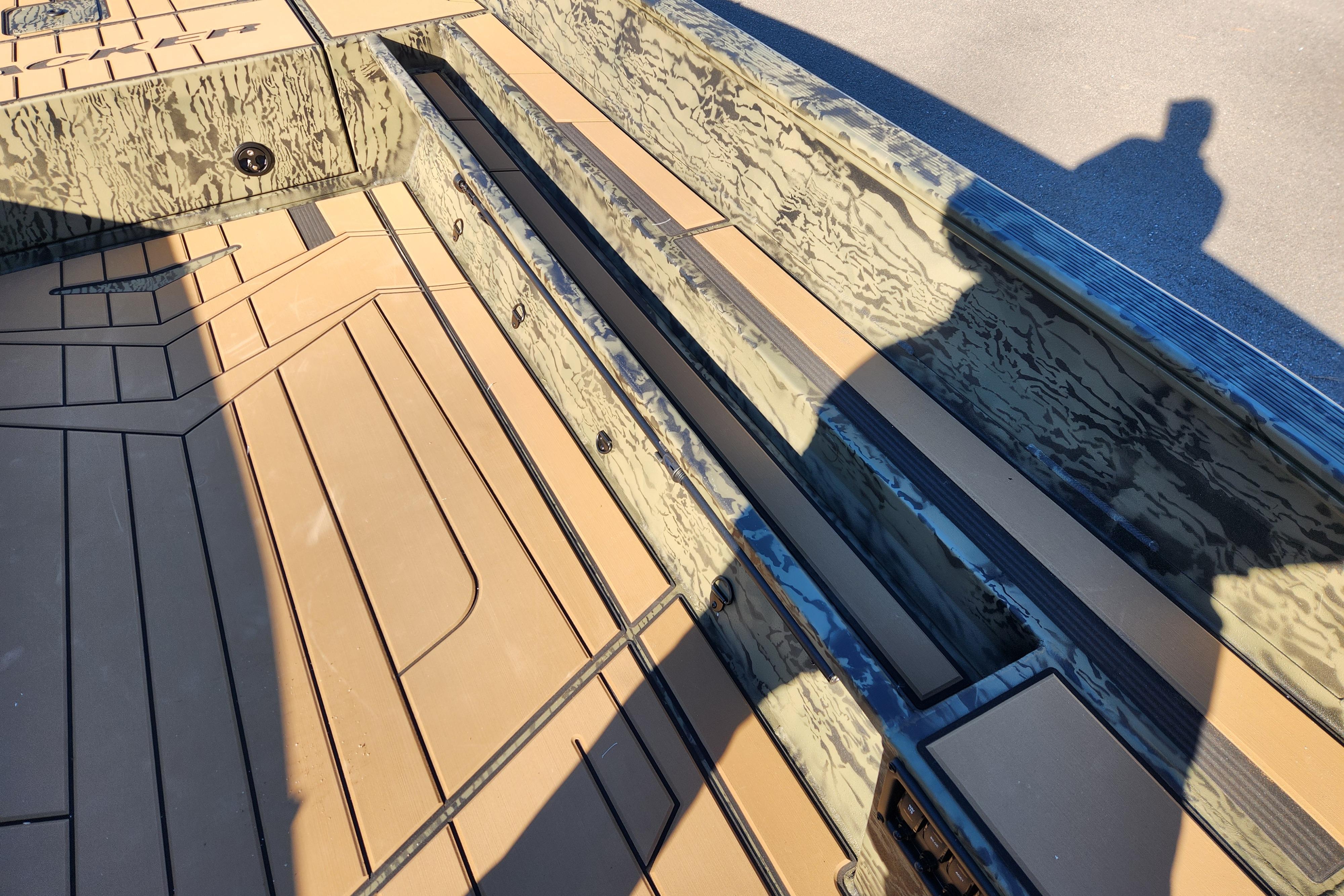 2026 Tracker Grizzly 1756 T Marsh boat interior with camouflage design and tan flooring.