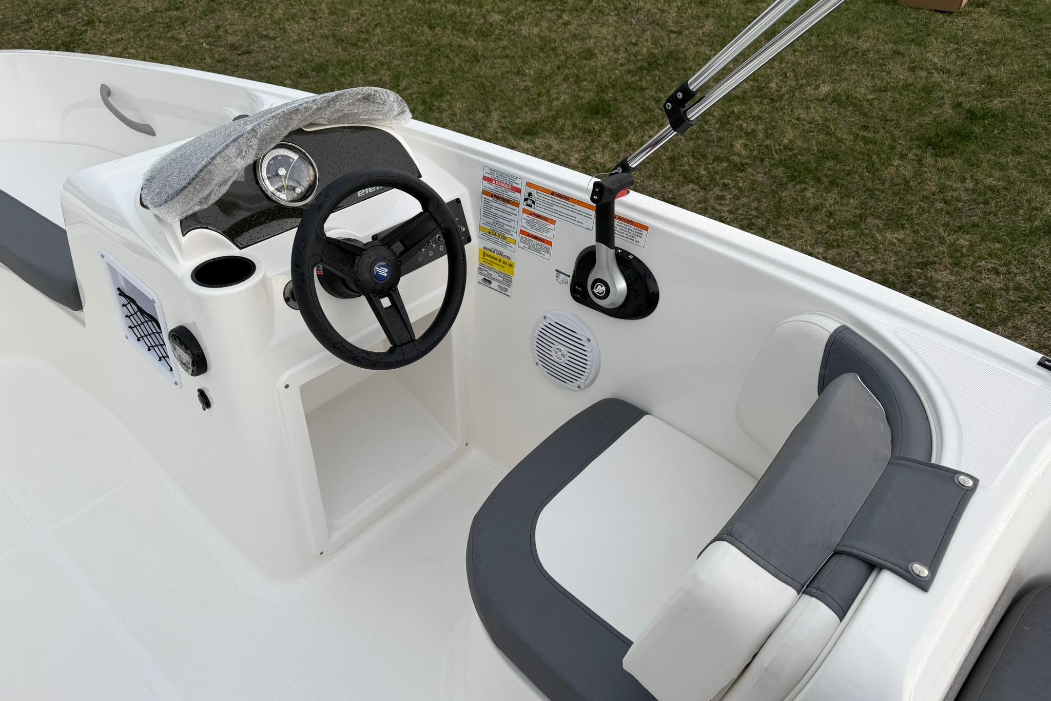 2026 Bayliner Element E16 boat interior with steering wheel and seating.