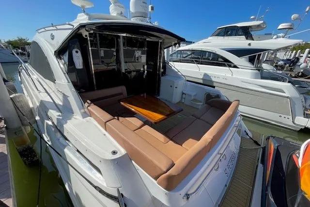 2016 Sea Ray Sundancer 510 yacht with spacious deck and luxurious seating at marina.
