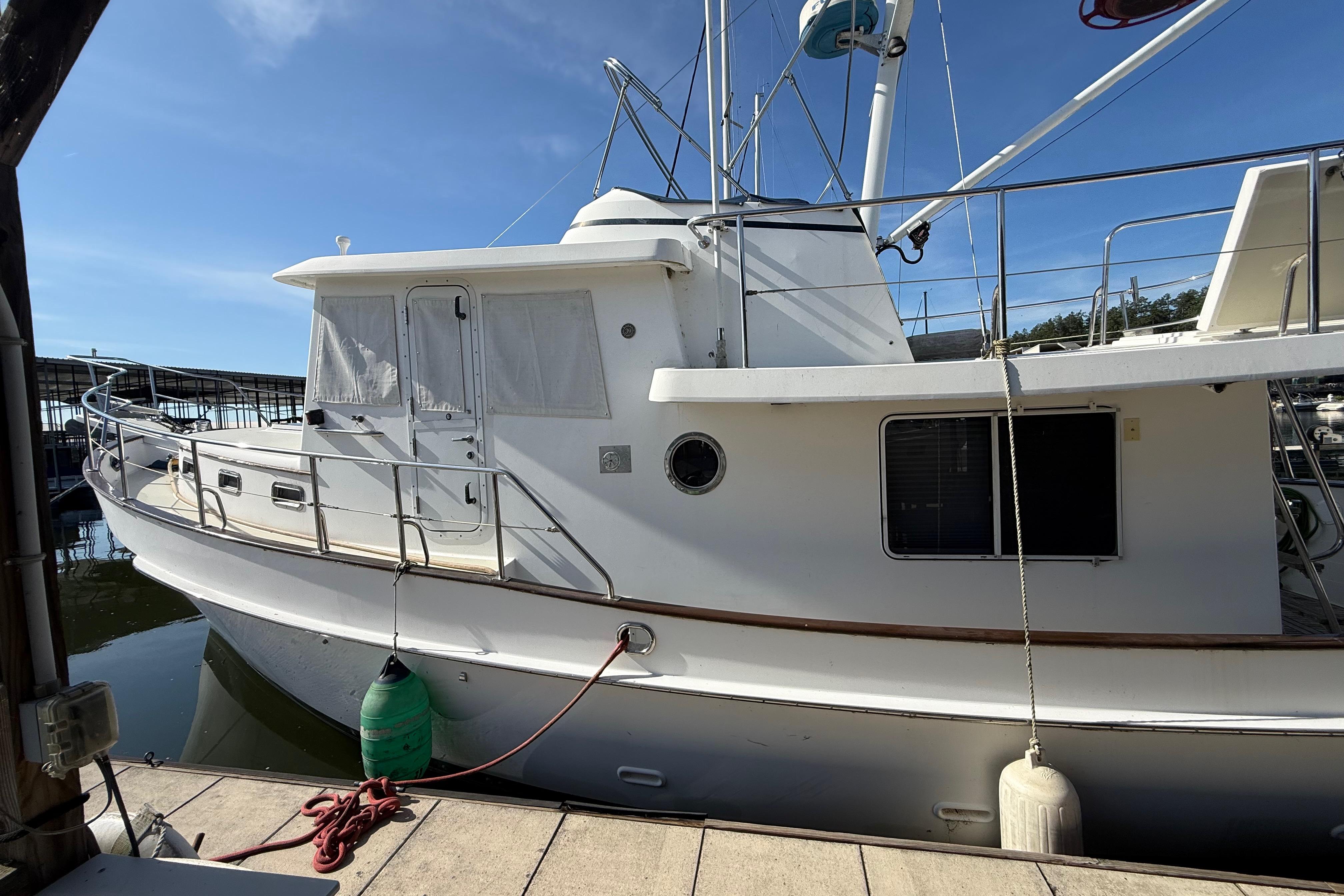2001 Kadey-Krogen 39 yacht docked at marina under clear blue sky.