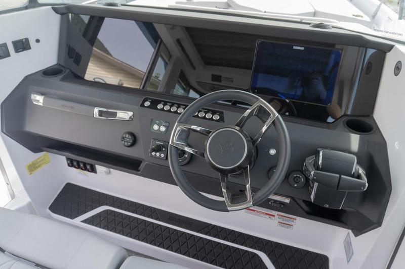 2025 Axopar 29 XC Cross Cabin dashboard with steering wheel and control panel.