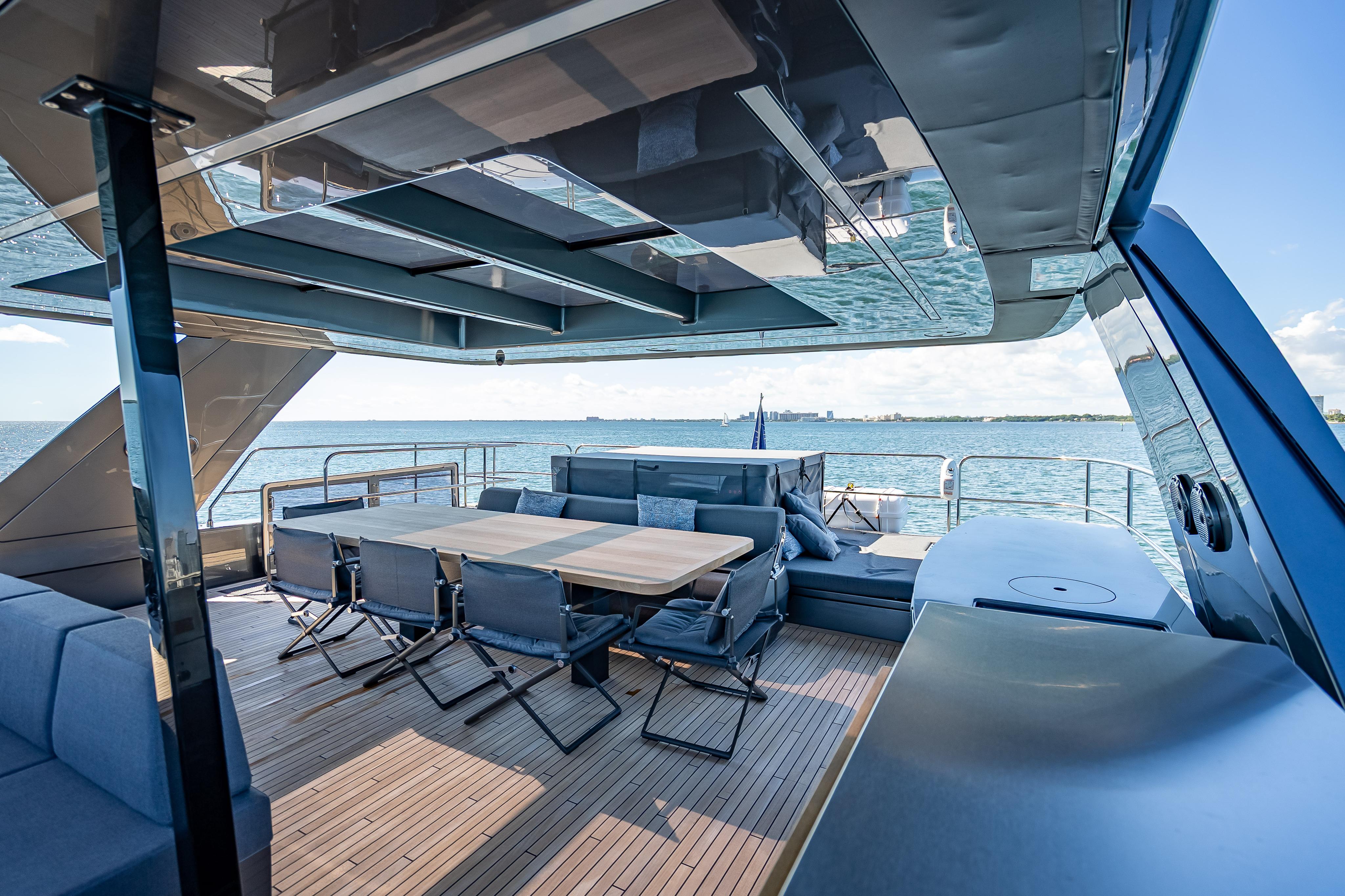Luxurious Sunreef 60 Power yacht deck with seating, dining area, and ocean view, 2026 model.