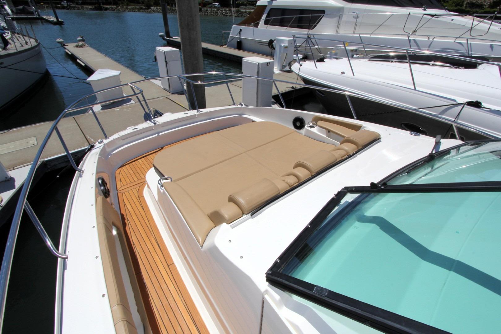 2021 Sea Ray Sundancer 320 Outboard with tan sunbed, docked at marina.
