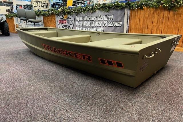 2026 Tracker Grizzly 10 Jon boat displayed indoors, featuring a durable design and olive green color.