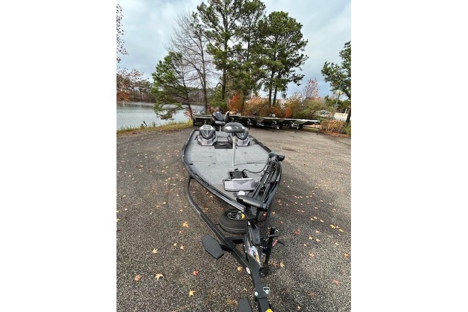 2025 Ranger ALPHA 208 boat parked near a scenic lake with trees.