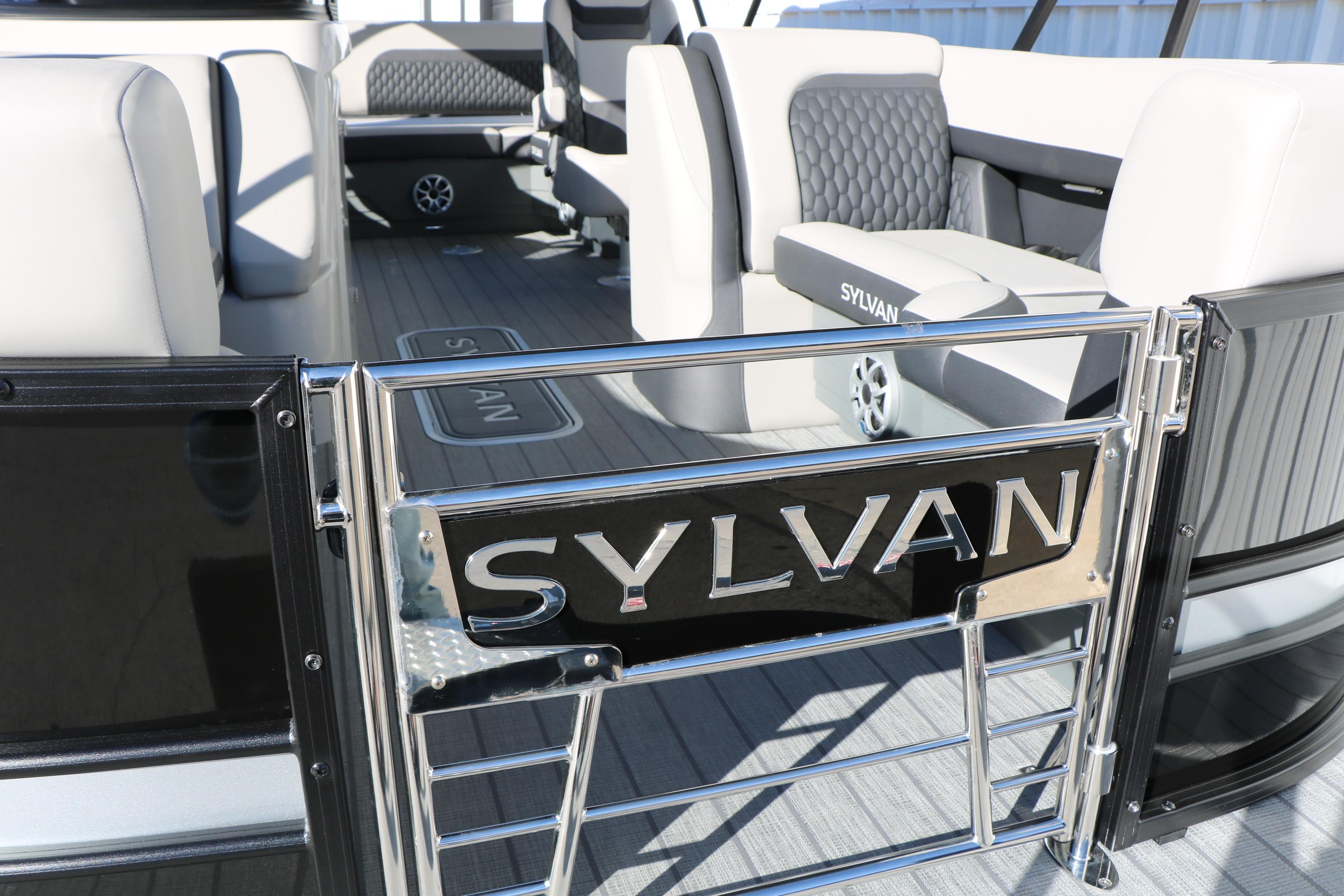 Interior of 2026 Sylvan L3 CLZ DH pontoon boat with stylish seating and branding.