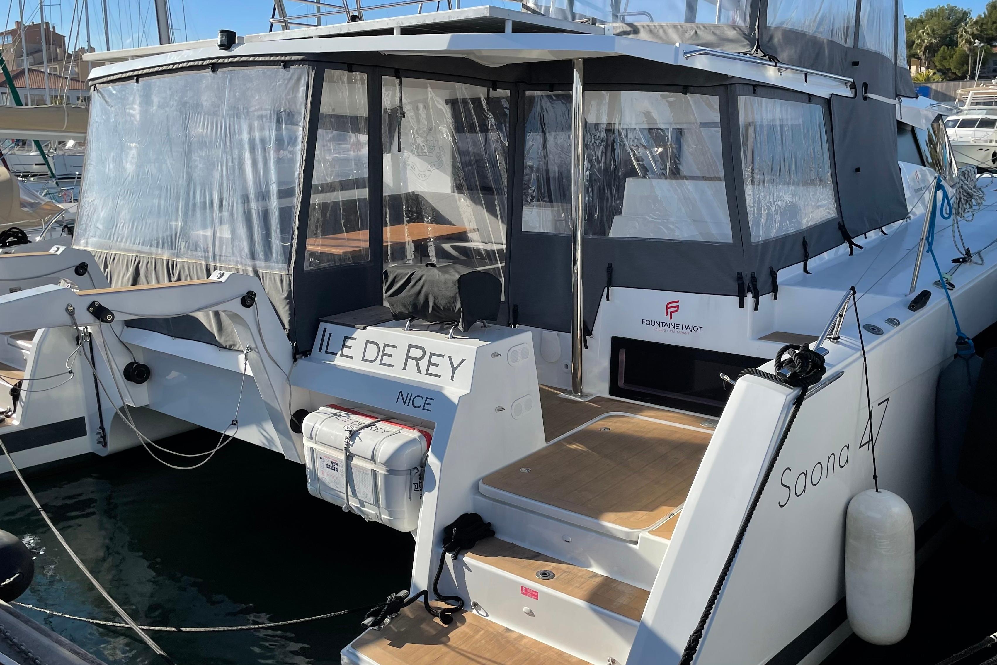 2020 Fountaine Pajot Saona 47 catamaran docked, featuring spacious deck and protective canopy.