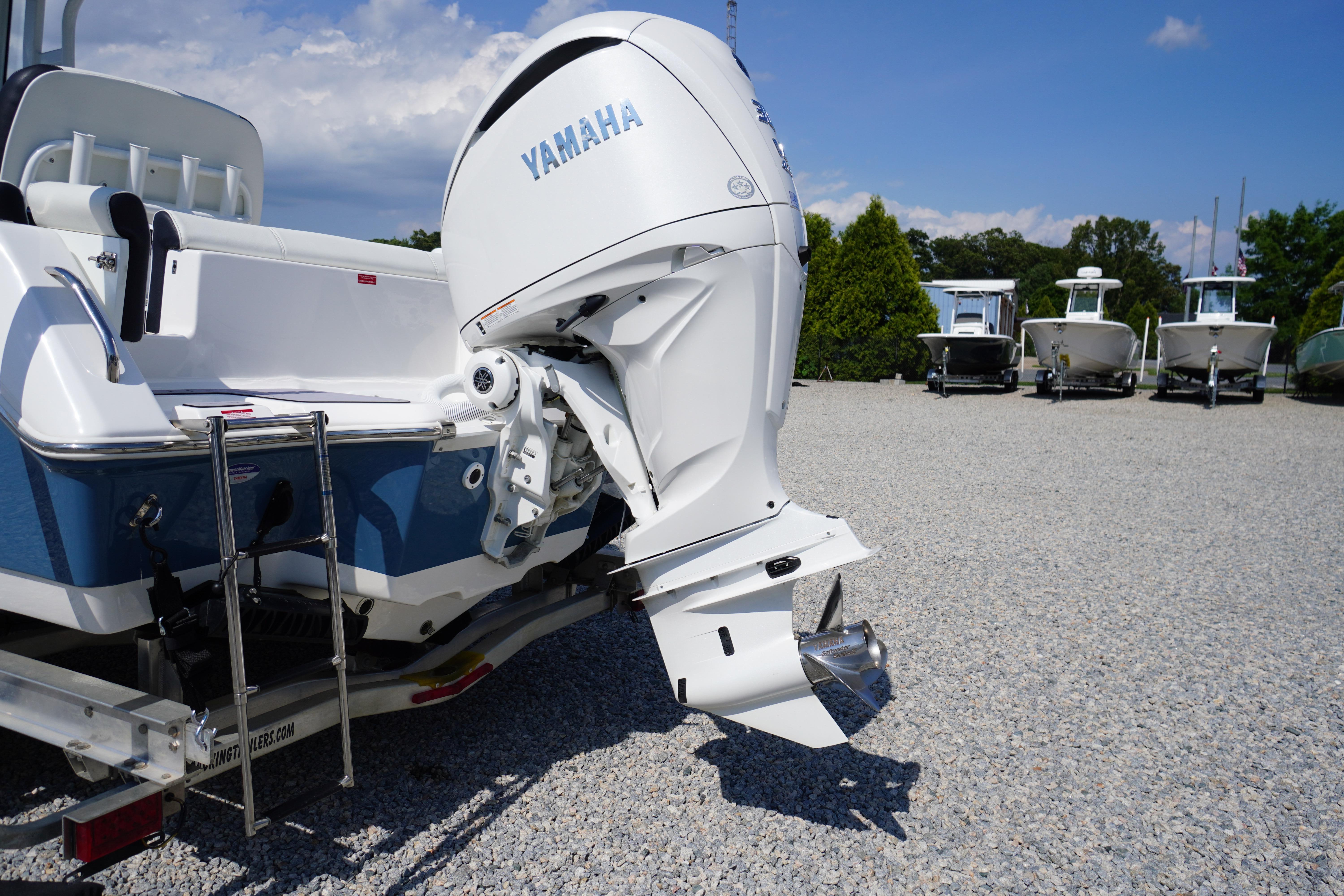 2025 Tidewater 232 SS boat with Yamaha outboard motor on gravel lot.