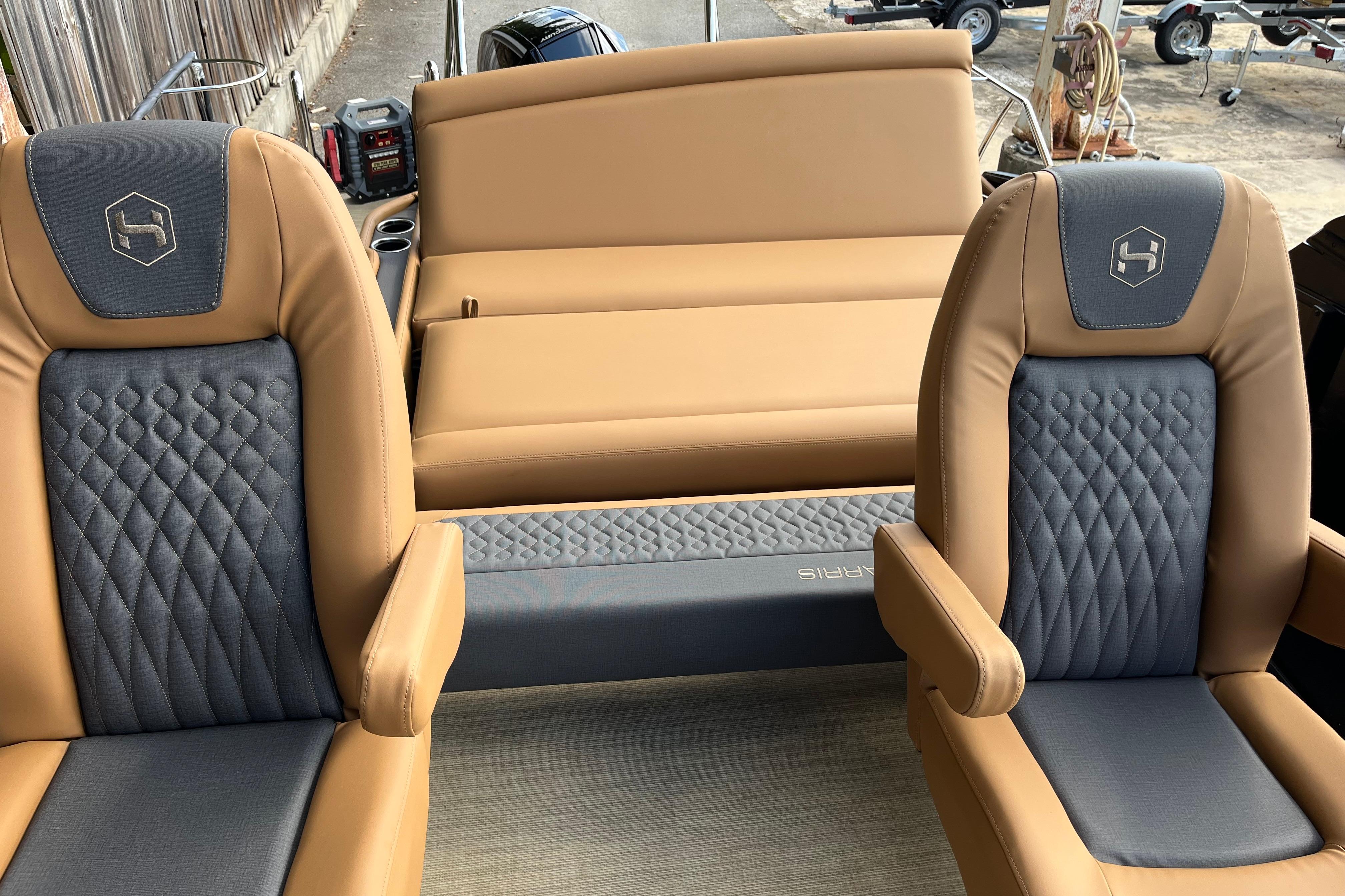 2025 Harris Sunliner 250 boat interior with tan and gray seating, featuring diamond stitching.