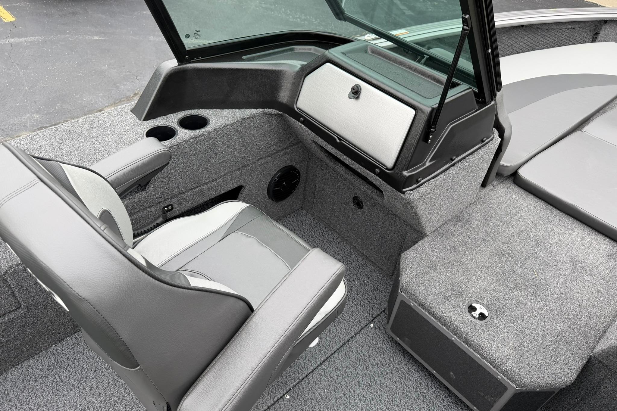 Interior of 2027 Lund 2075 Impact XS boat with gray seating and storage compartments.