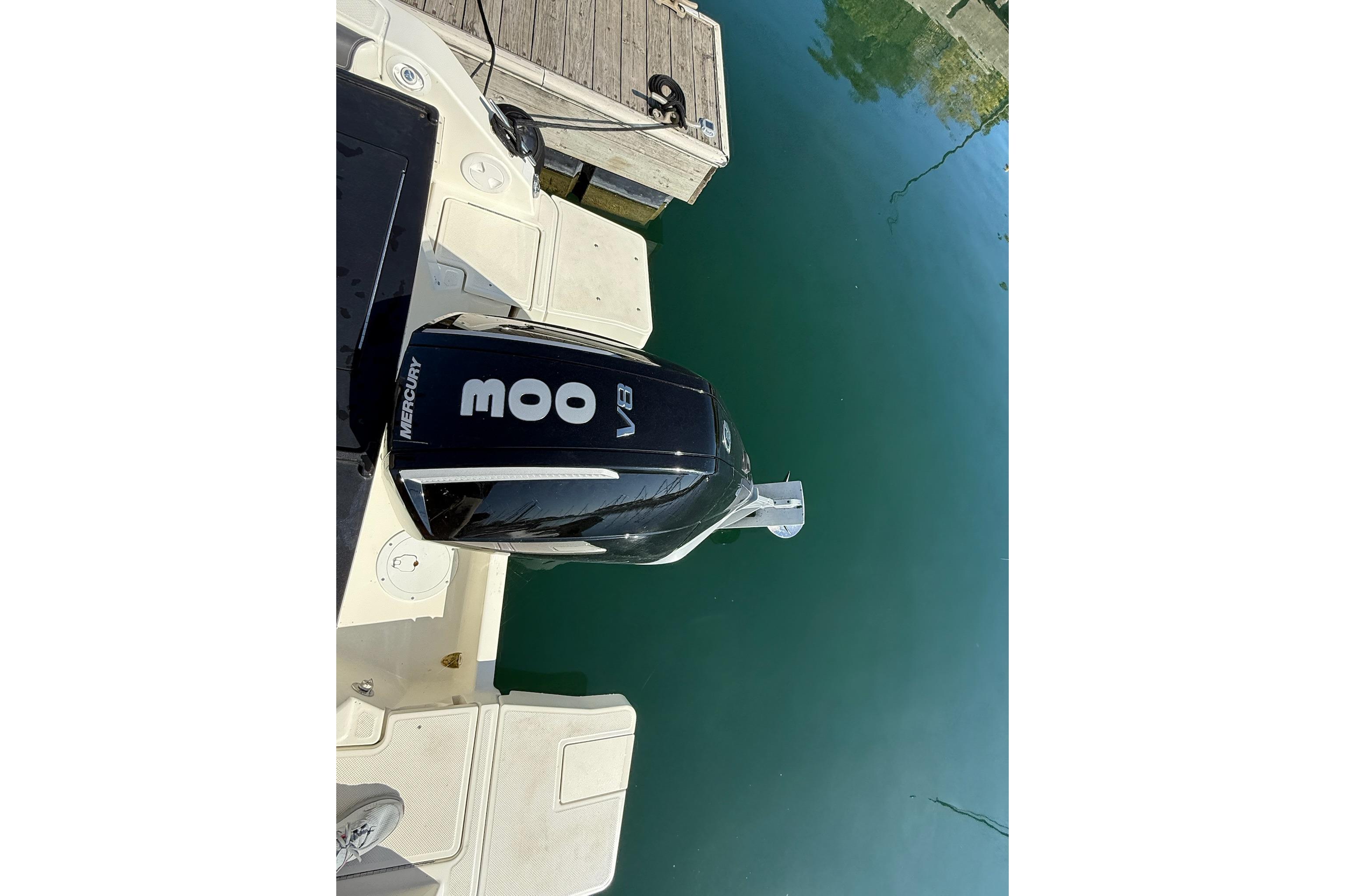 2024 Bayliner Trophy T25 Pilothouse with Mercury 300 V8 engine at dock.