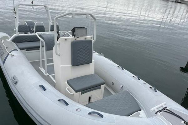 2017 Highfield OM 500 inflatable boat with grey seating on calm water.