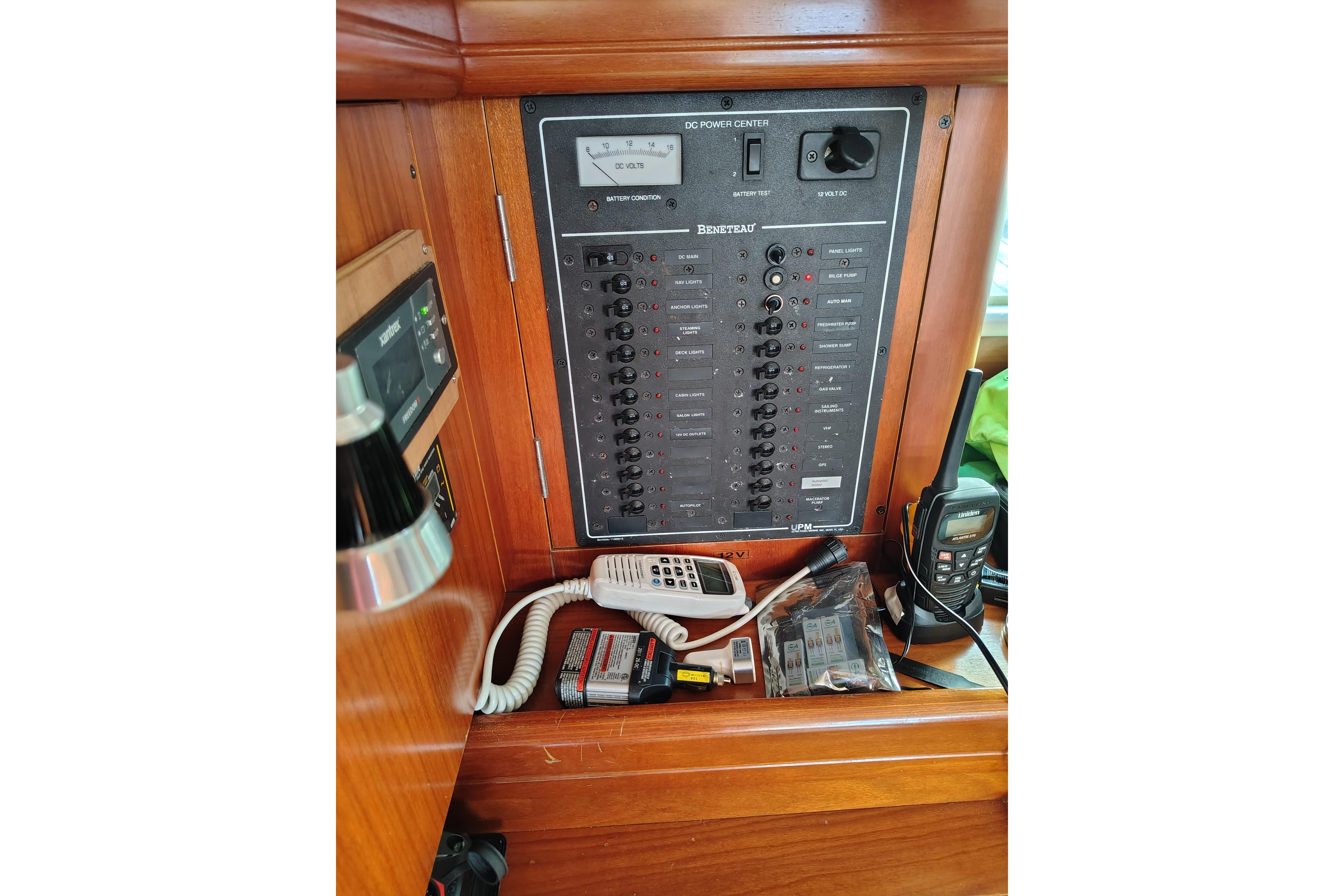 Electrical control panel on a 2001 Beneteau Oceanis 411 sailboat, featuring various switches and devices.