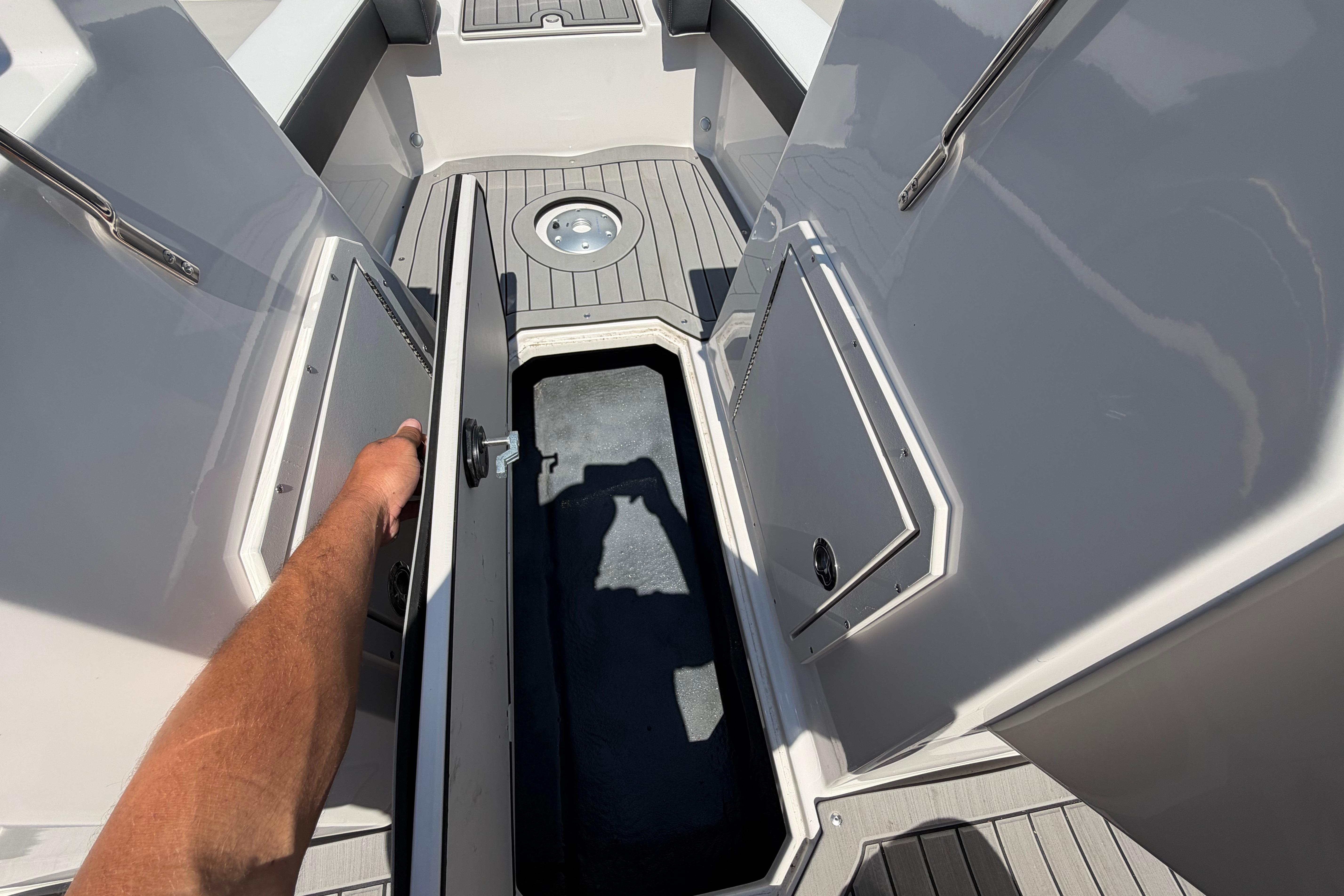 2025 Starcraft SVX 190 OB boat interior with storage compartment open.