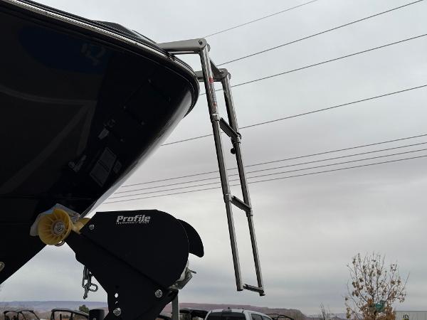 2025 Yamaha Boats 255XD with ladder, overcast sky background.