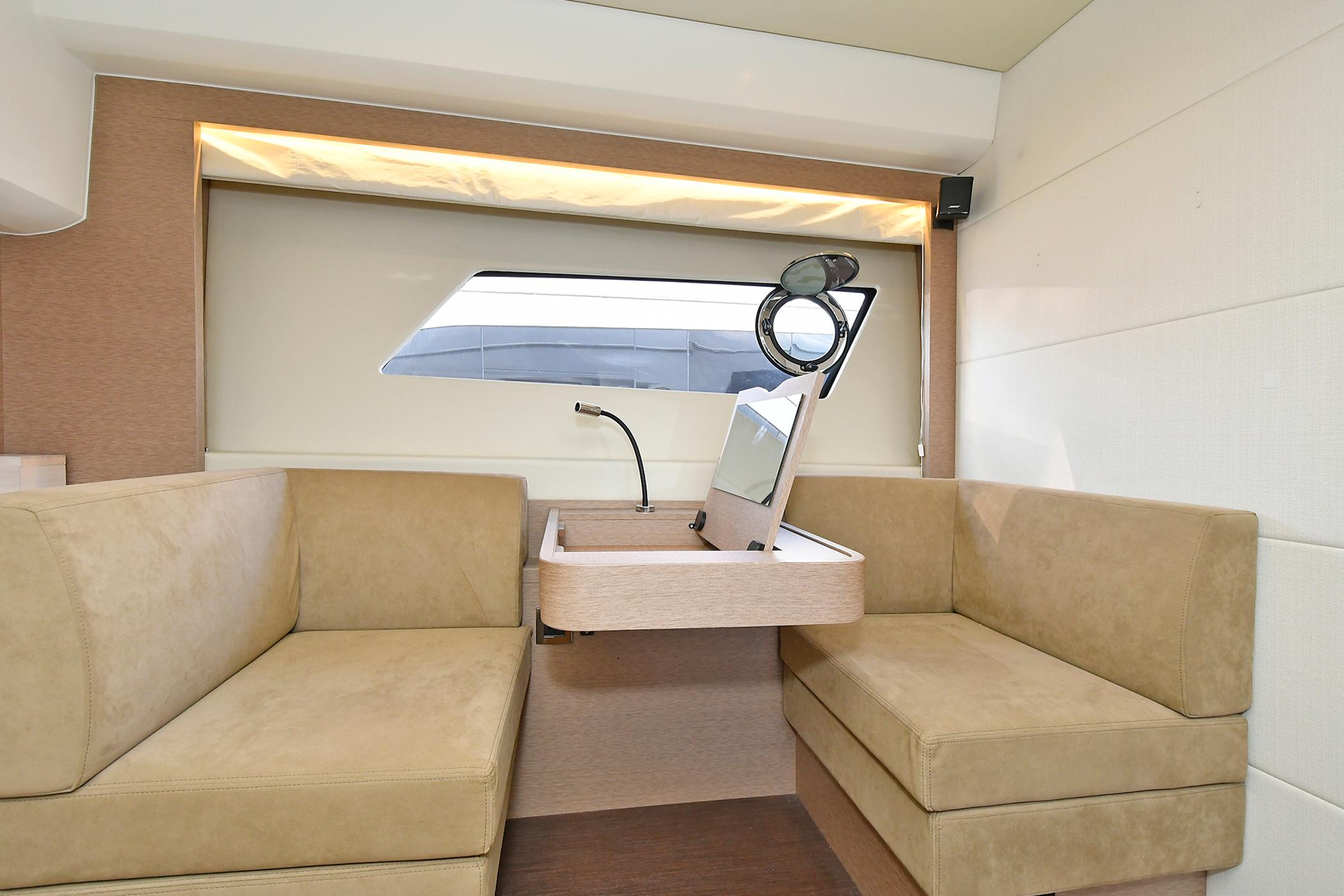 Interior of 2018 Prestige 560 Fly yacht with beige seating and modern design.