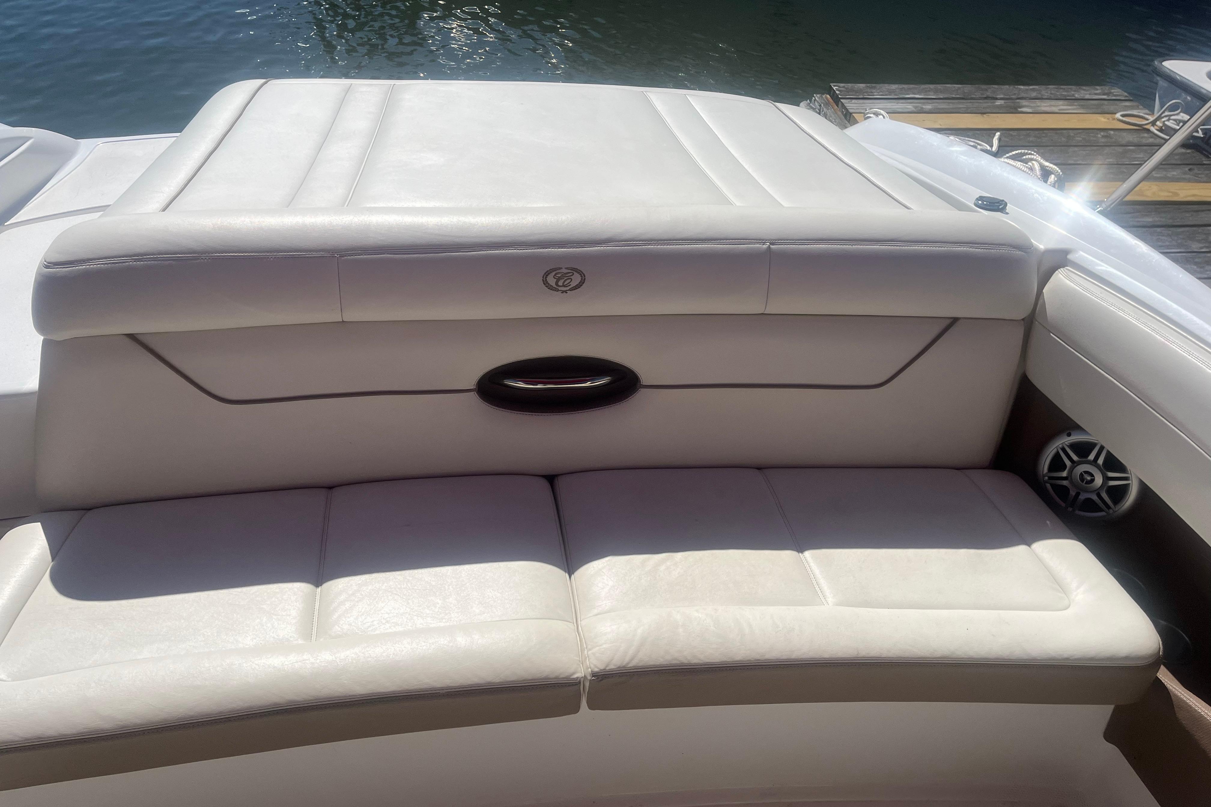 2011 Cobalt 210 boat with white leather seating, docked by the water.