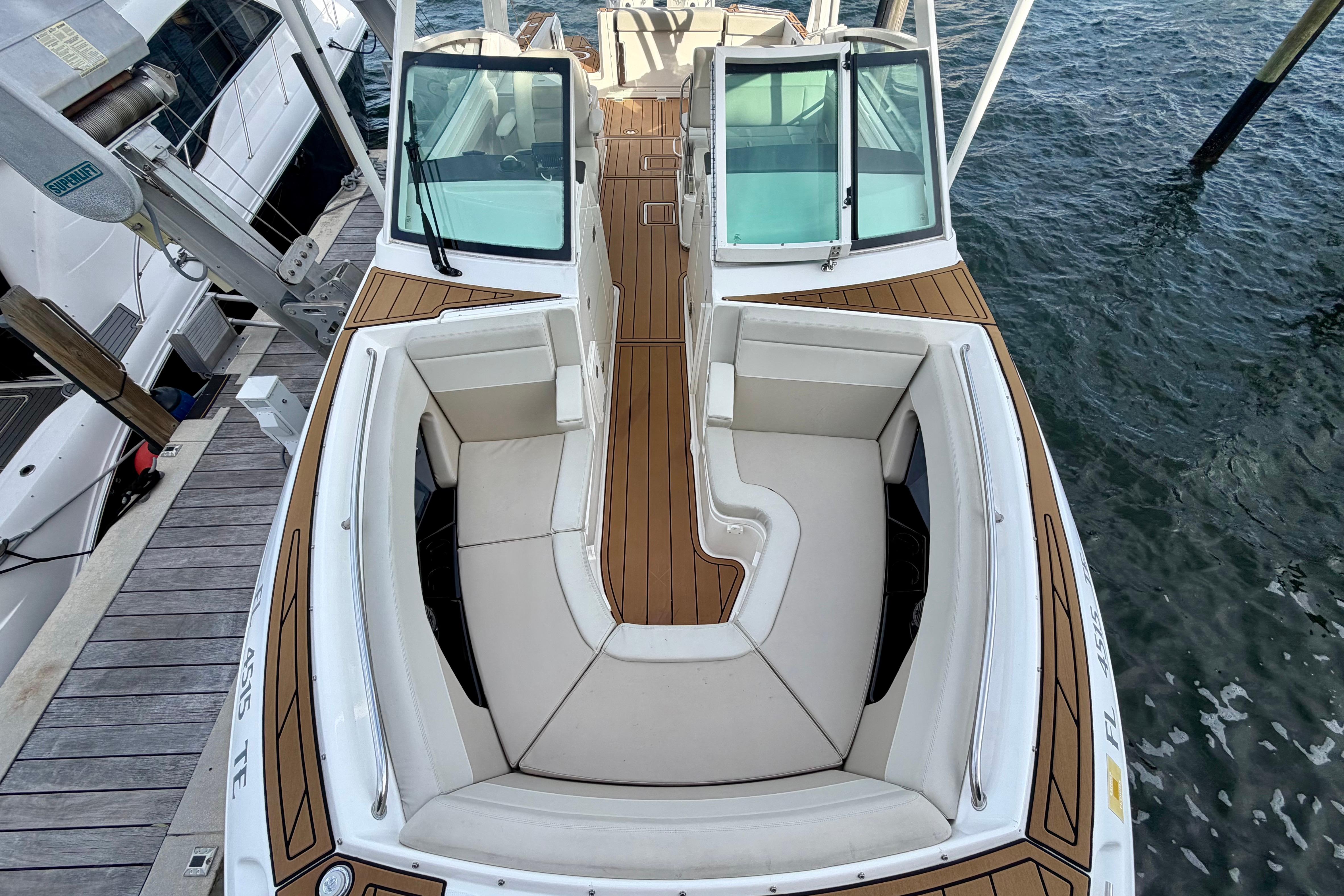2022 Boston Whaler 280 Vantage boat with spacious seating and elegant design docked by the water.