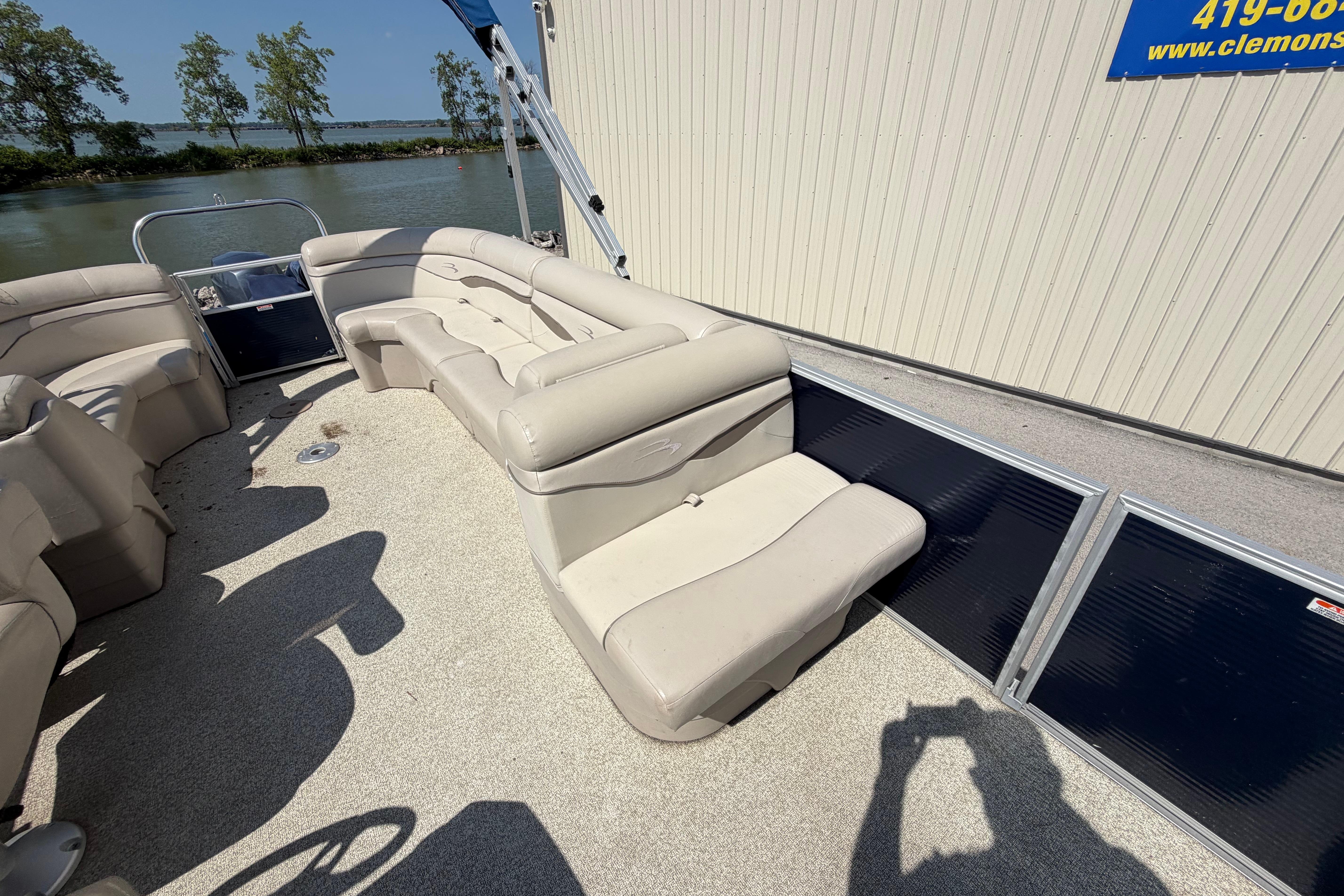 2017 Bennington 25 SSXAPG pontoon boat interior with beige seating and lake view.