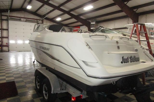2004 Stingray 240 LR boat in indoor storage on a trailer.