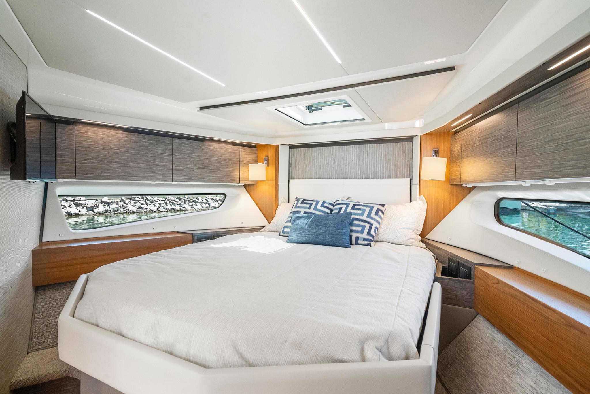 Luxurious bedroom interior of 2022 Tiara Yachts C49 Coupe with modern design and natural light.