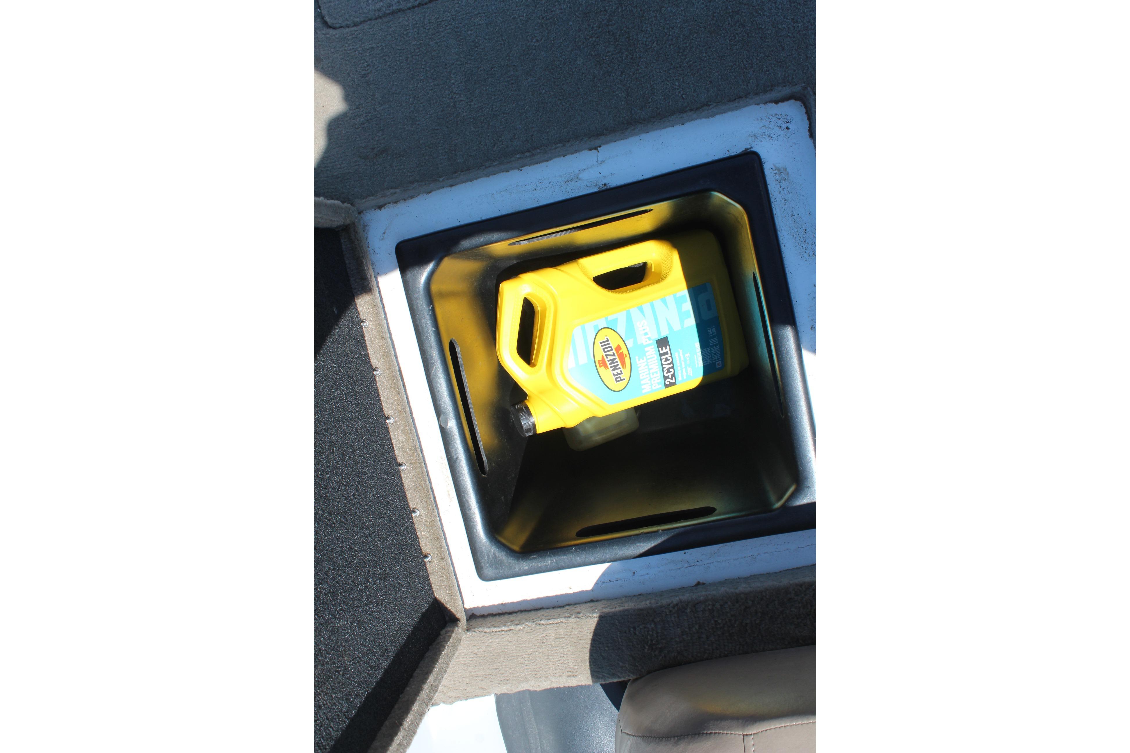 Yellow oil container in storage compartment of 2003 Nitro NX 750 SC boat.