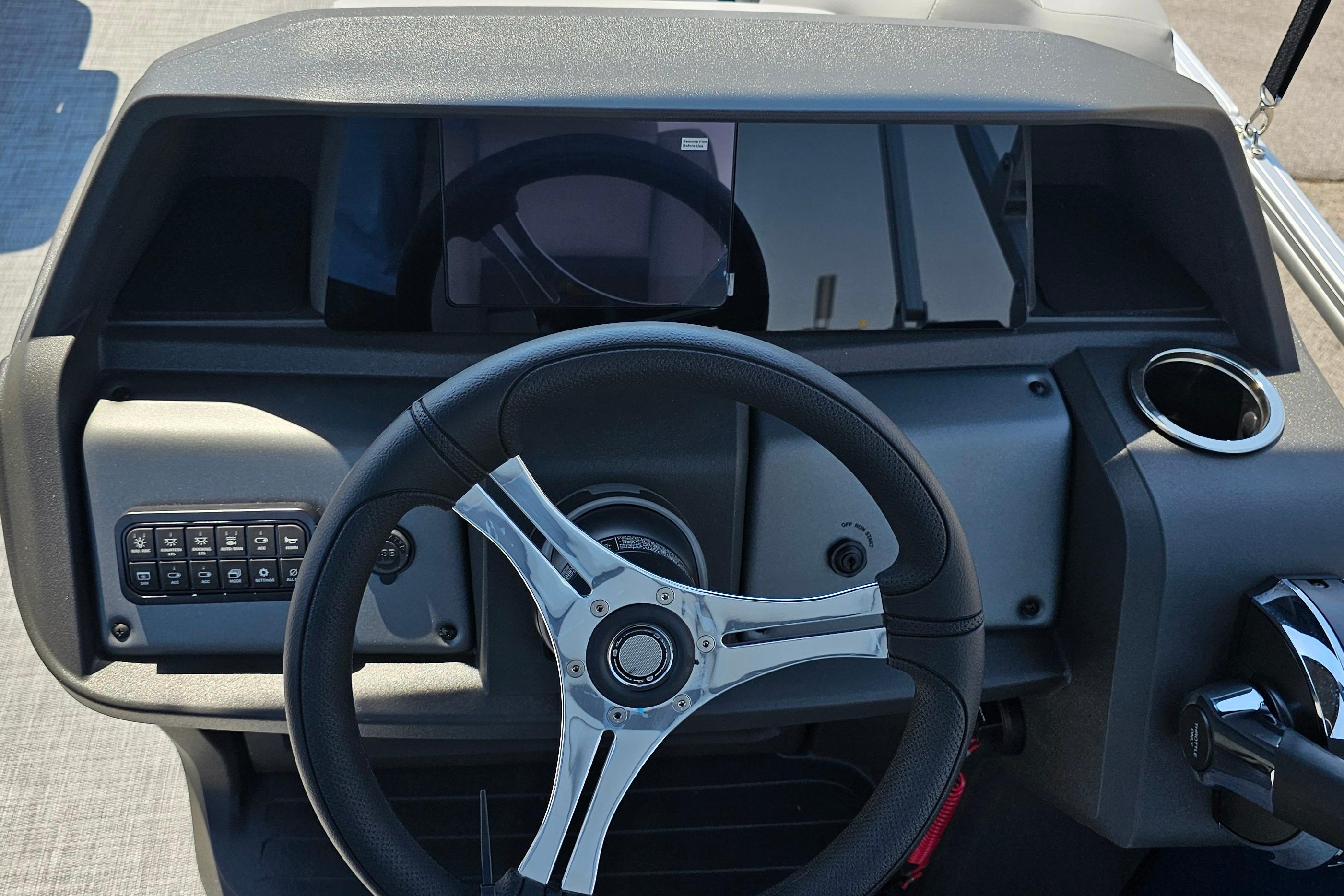 Steering console of 2026 Sun Tracker SportFish 20 DLX boat with modern controls.