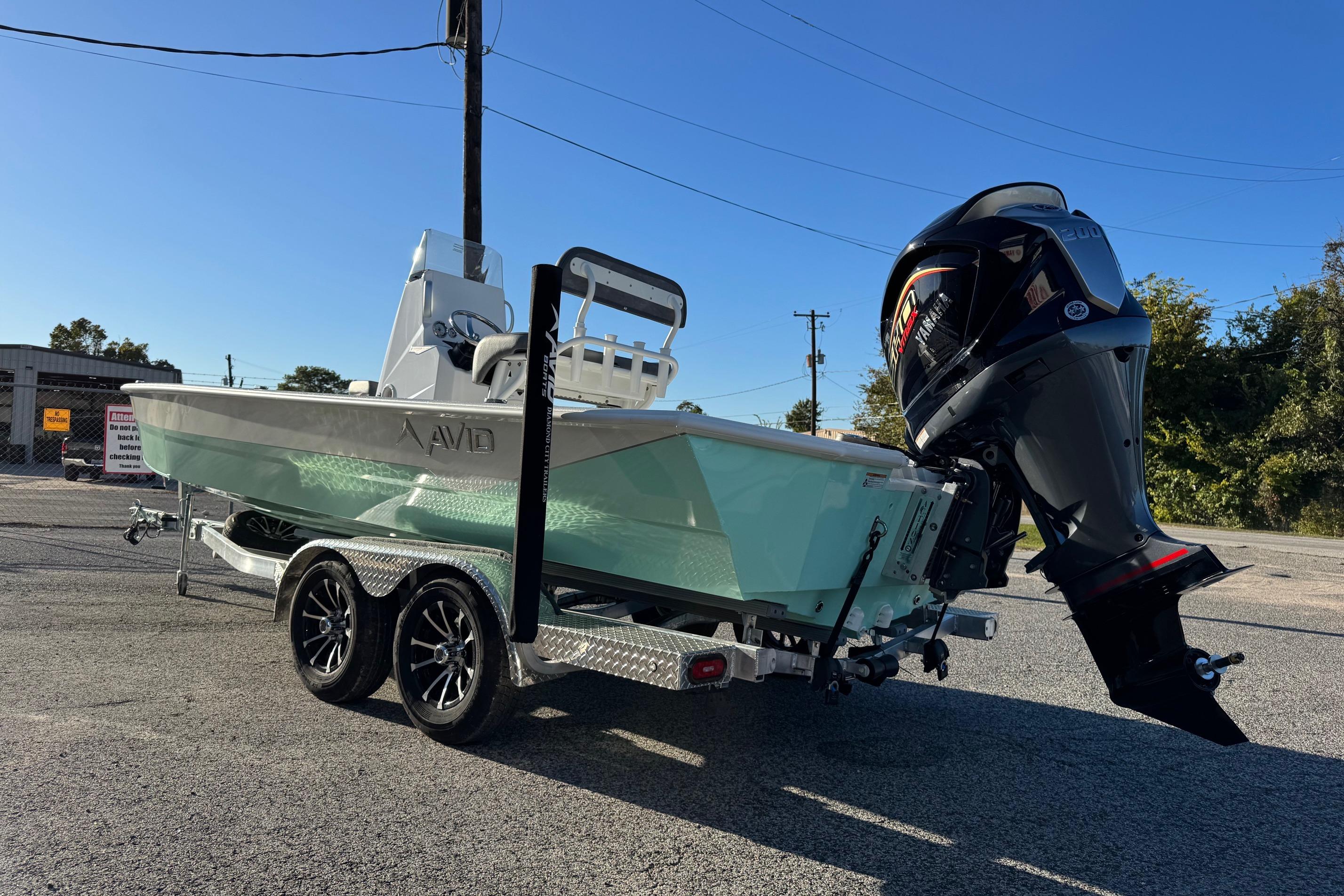 2025 Avid 23 Mag boat on trailer with Yamaha outboard motor, parked outdoors.