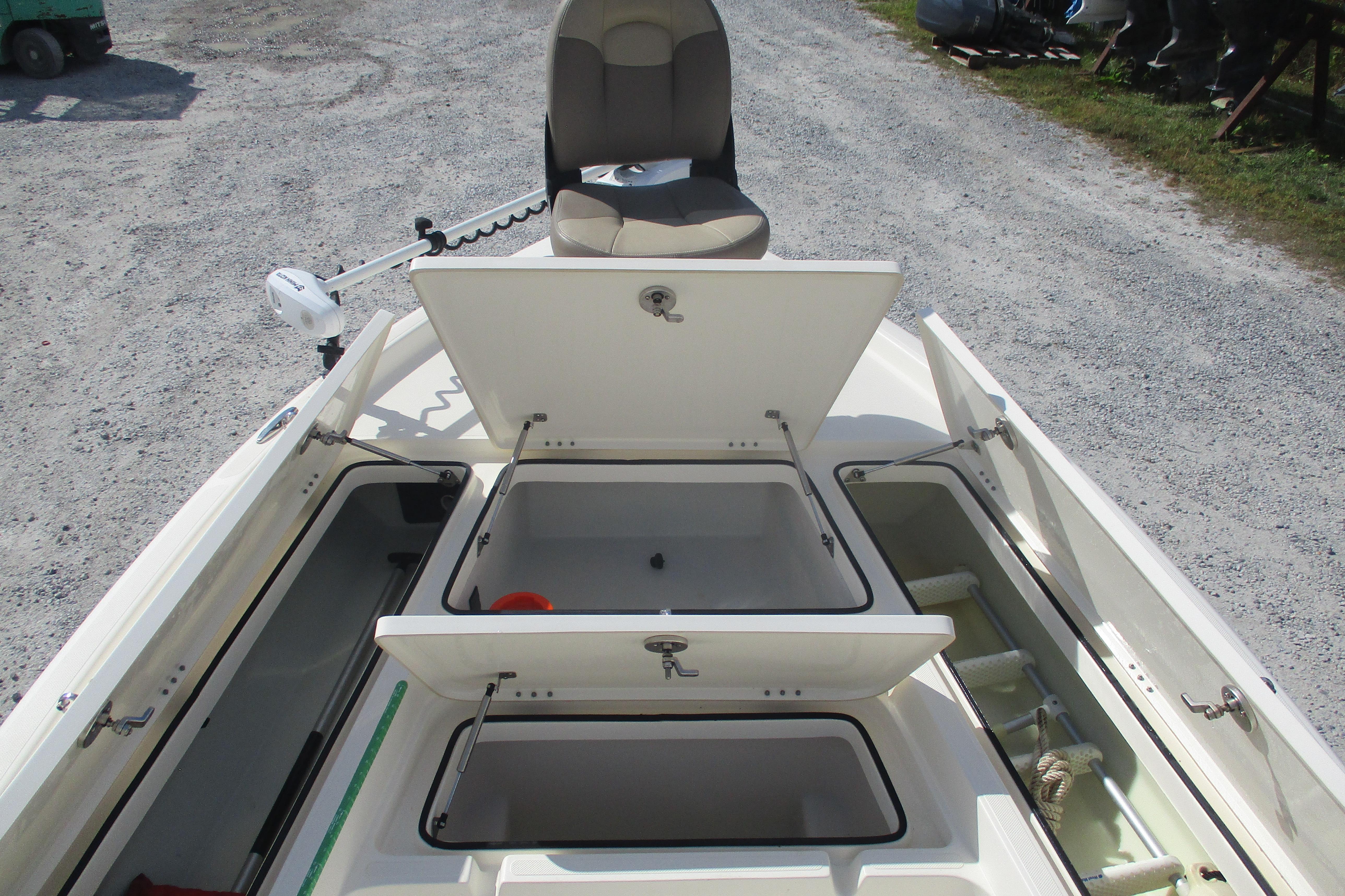 2014 Skeeter SX240 boat with open storage compartments and seating.