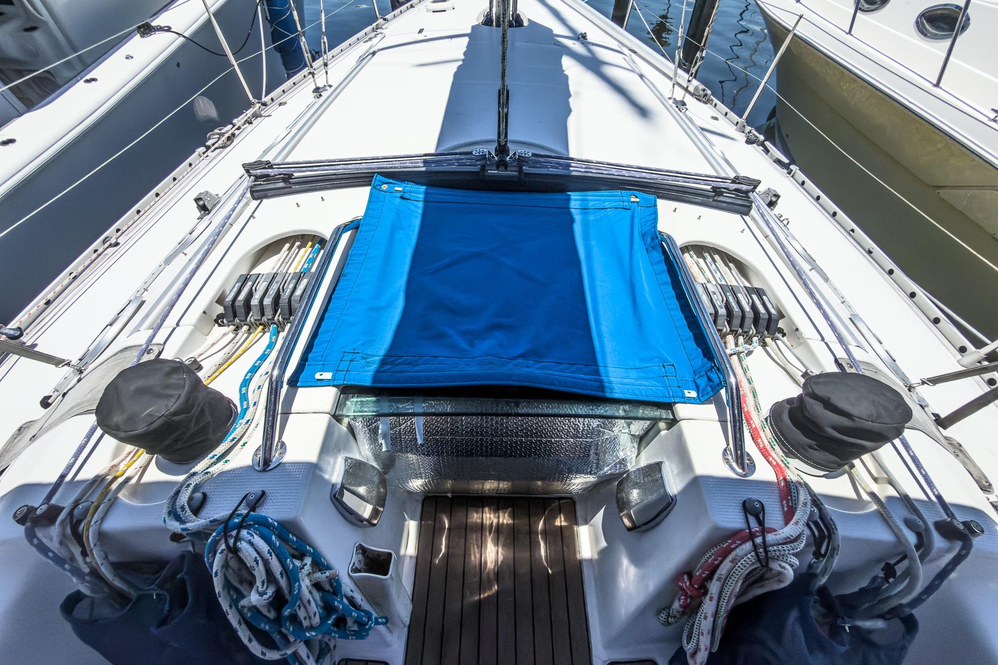 Deck view of a 1993 Beneteau First 38 s5 sailboat with blue canvas cover.