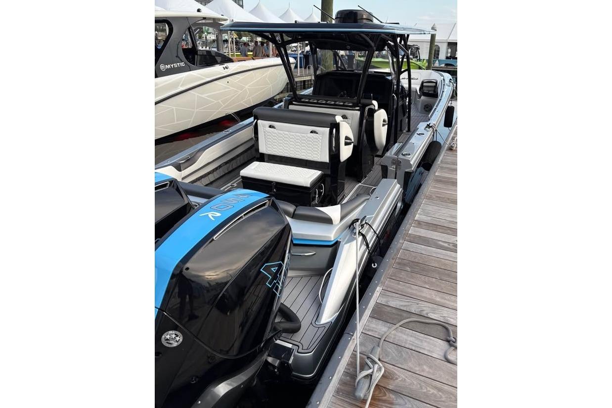 2022 Nor-Tech 390 Sport Center Console boat docked, showcasing sleek design and powerful engines.