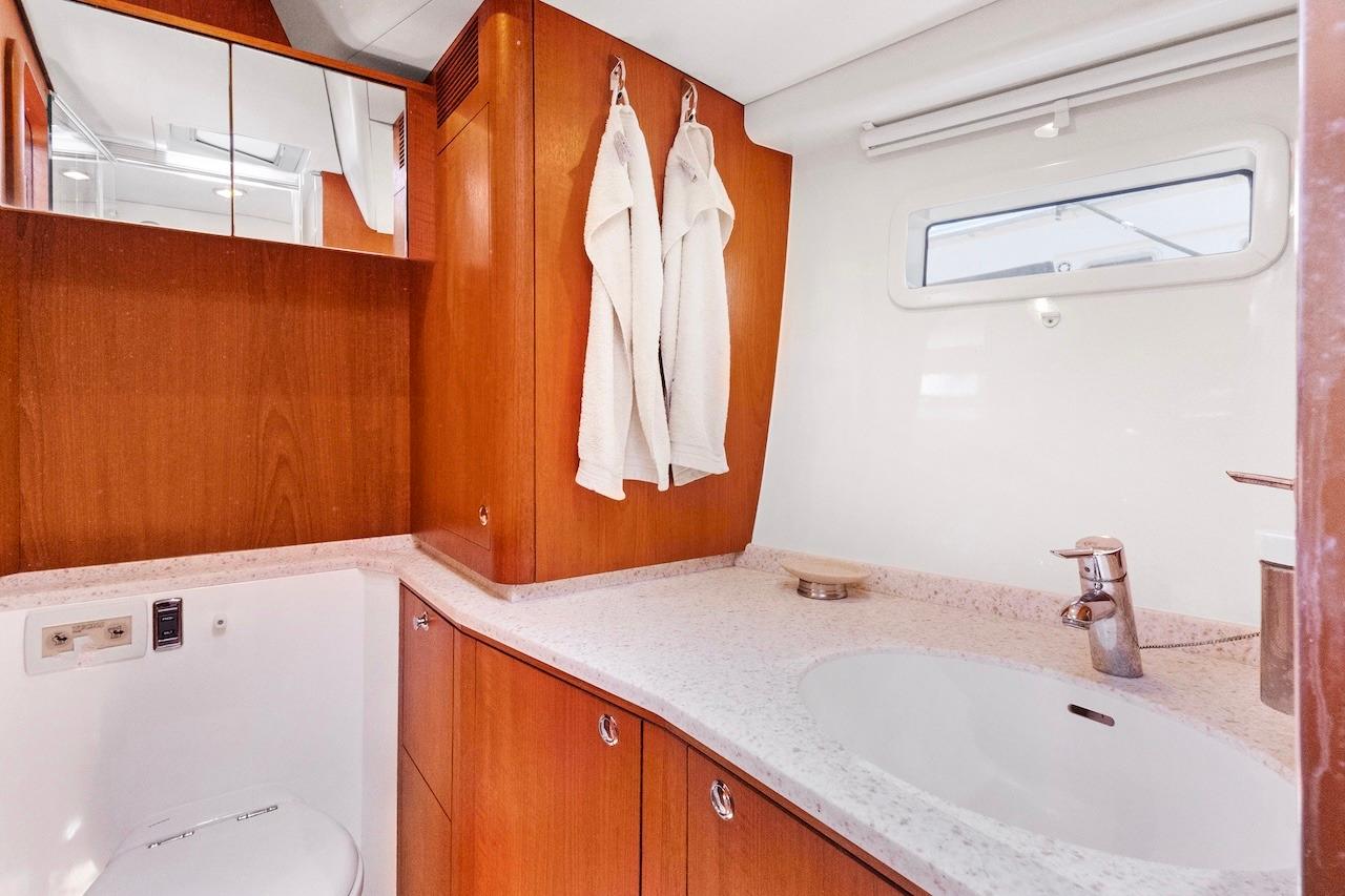 Luxurious bathroom interior of 2011 Southerly 57 RS yacht with wooden cabinetry.
