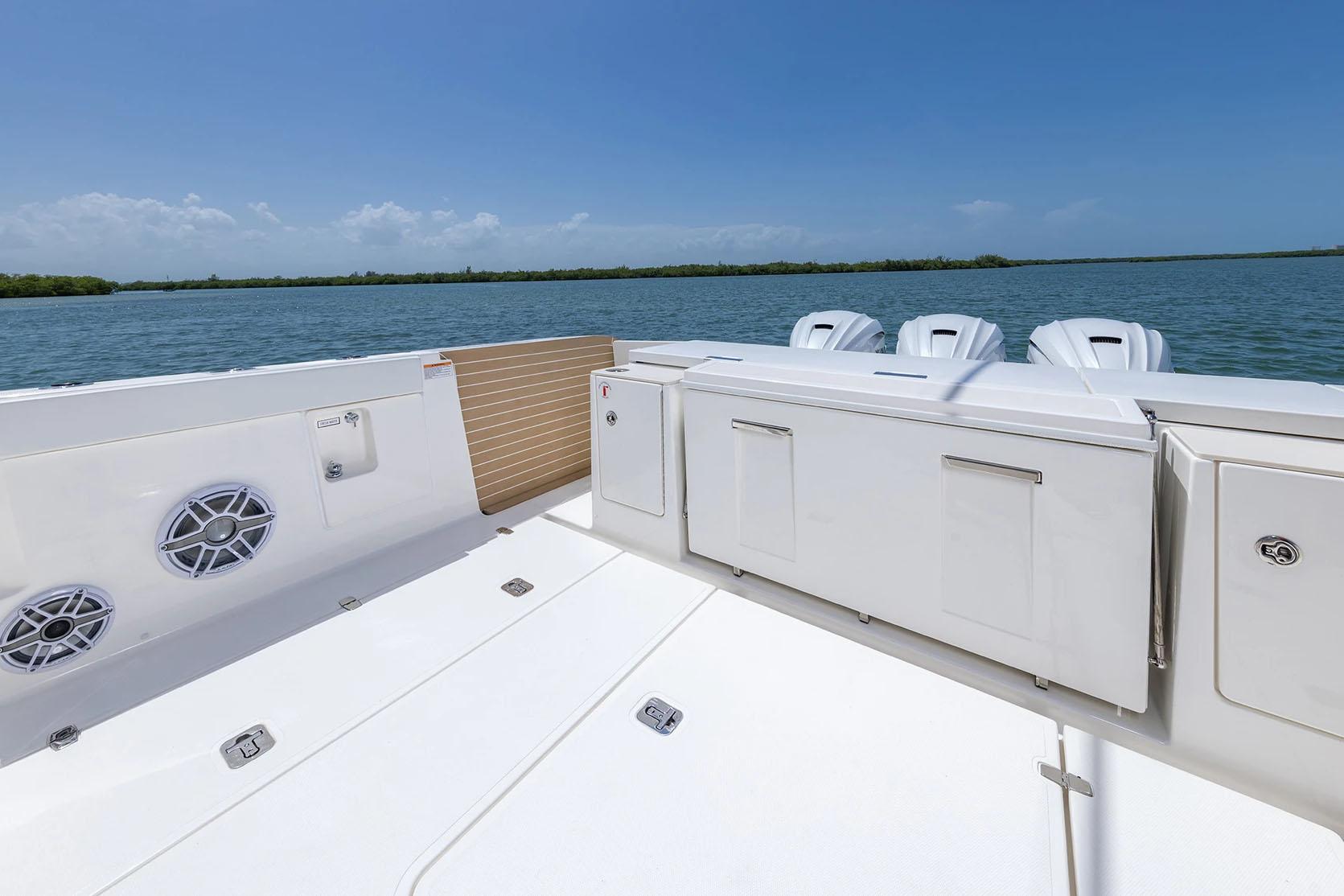Manufacturer Provided Image: 2025 Pursuit OS 445 Offshore boat deck with ocean view and triple engines.