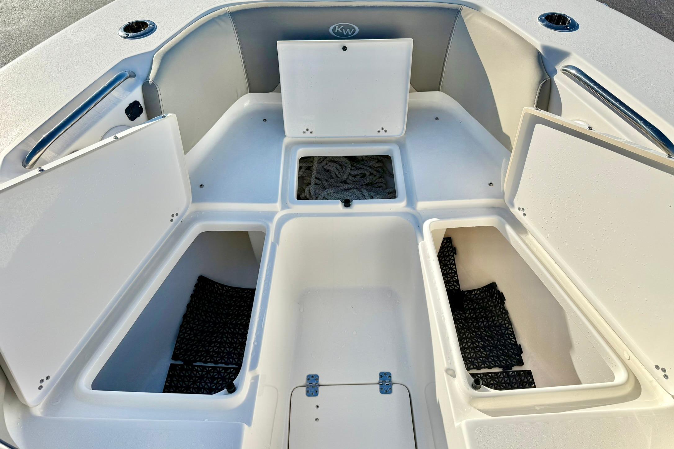 2021 Key West 263 FS boat storage compartments with open hatches, showcasing spacious interior.
