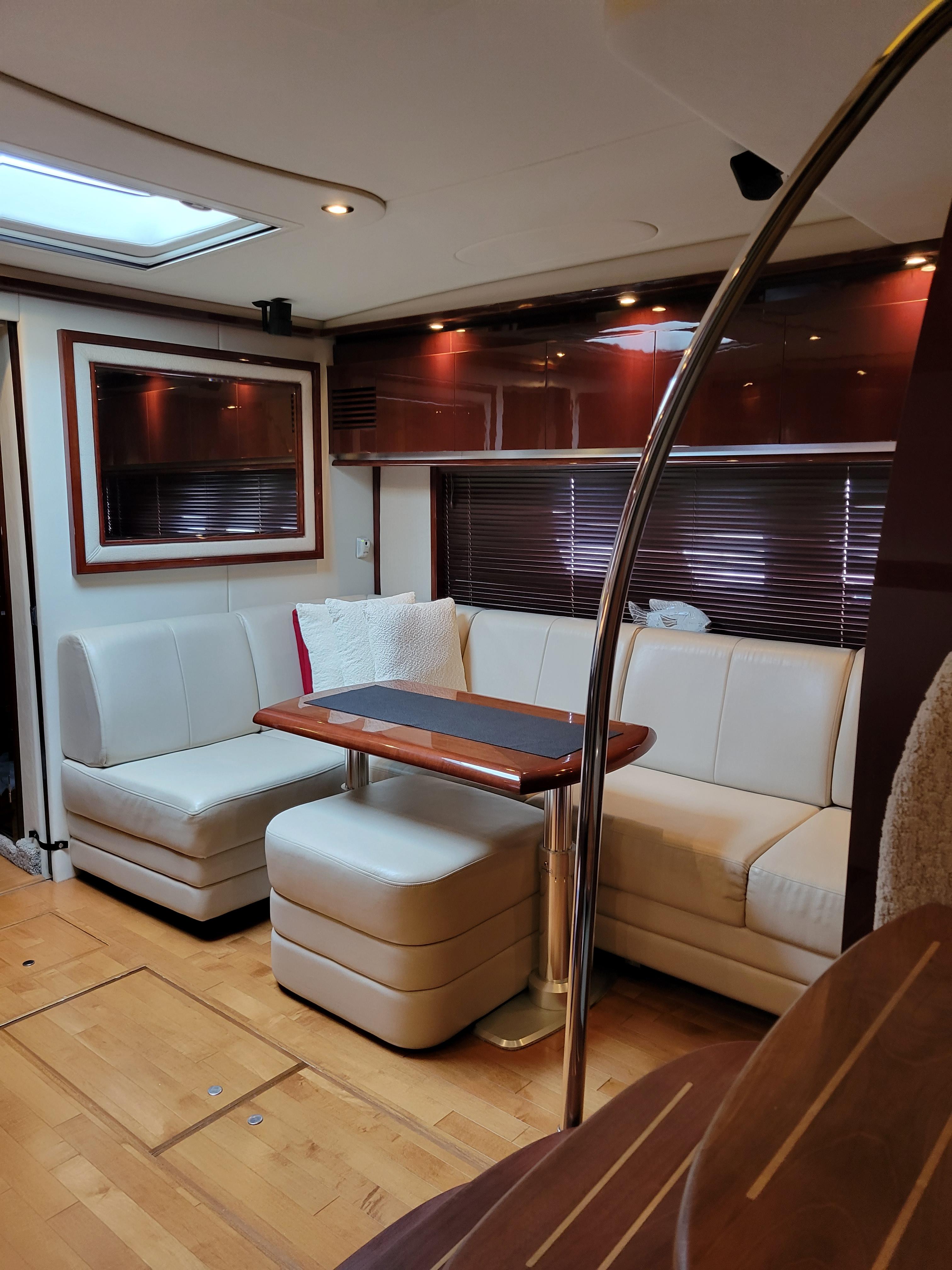 Luxurious interior of 2009 Sea Ray 500 Sundancer yacht with elegant seating and wooden accents.