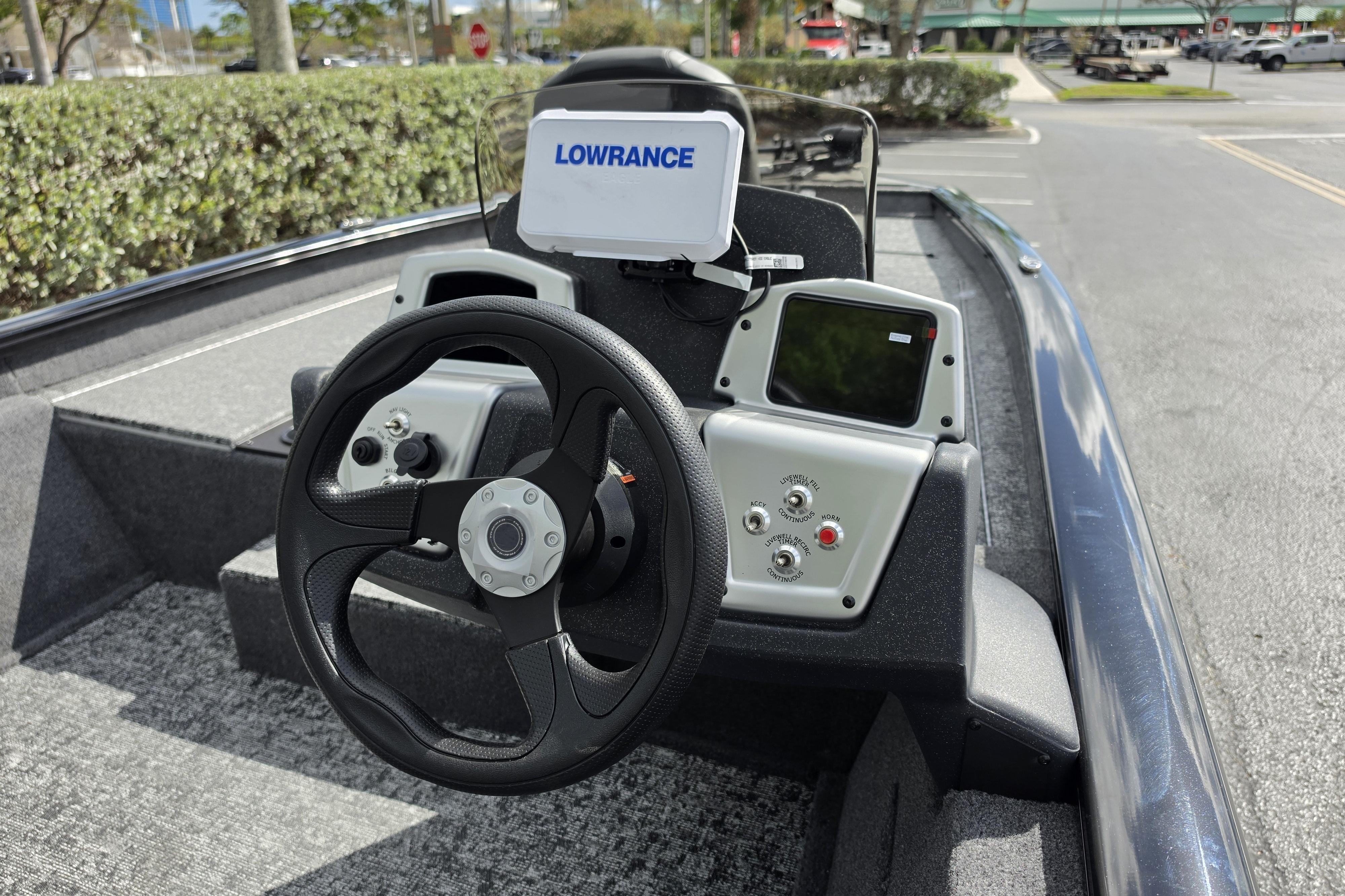 2026 Tracker Pro Team 190 boat dashboard with steering wheel and Lowrance navigation system.